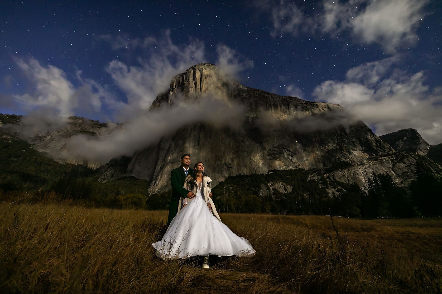 Wedding photo of bride and groom under the moon and stars.