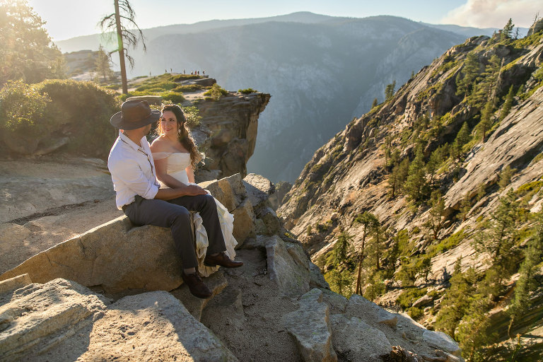 Couple gets wedding photography in Yosemite at Taft Point at sunset.