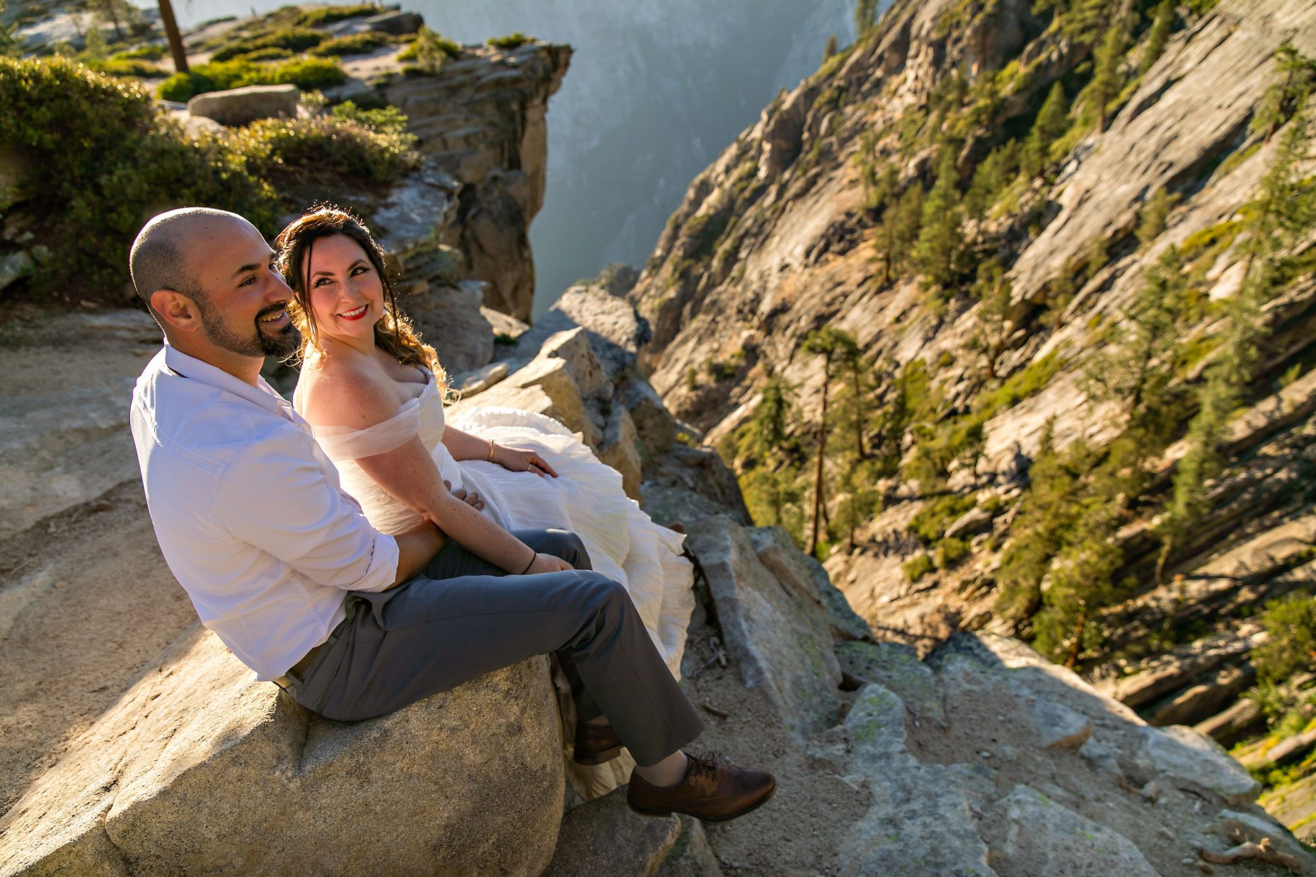 Couple gets wedding photography in Yosemite at Taft Point at sunset.