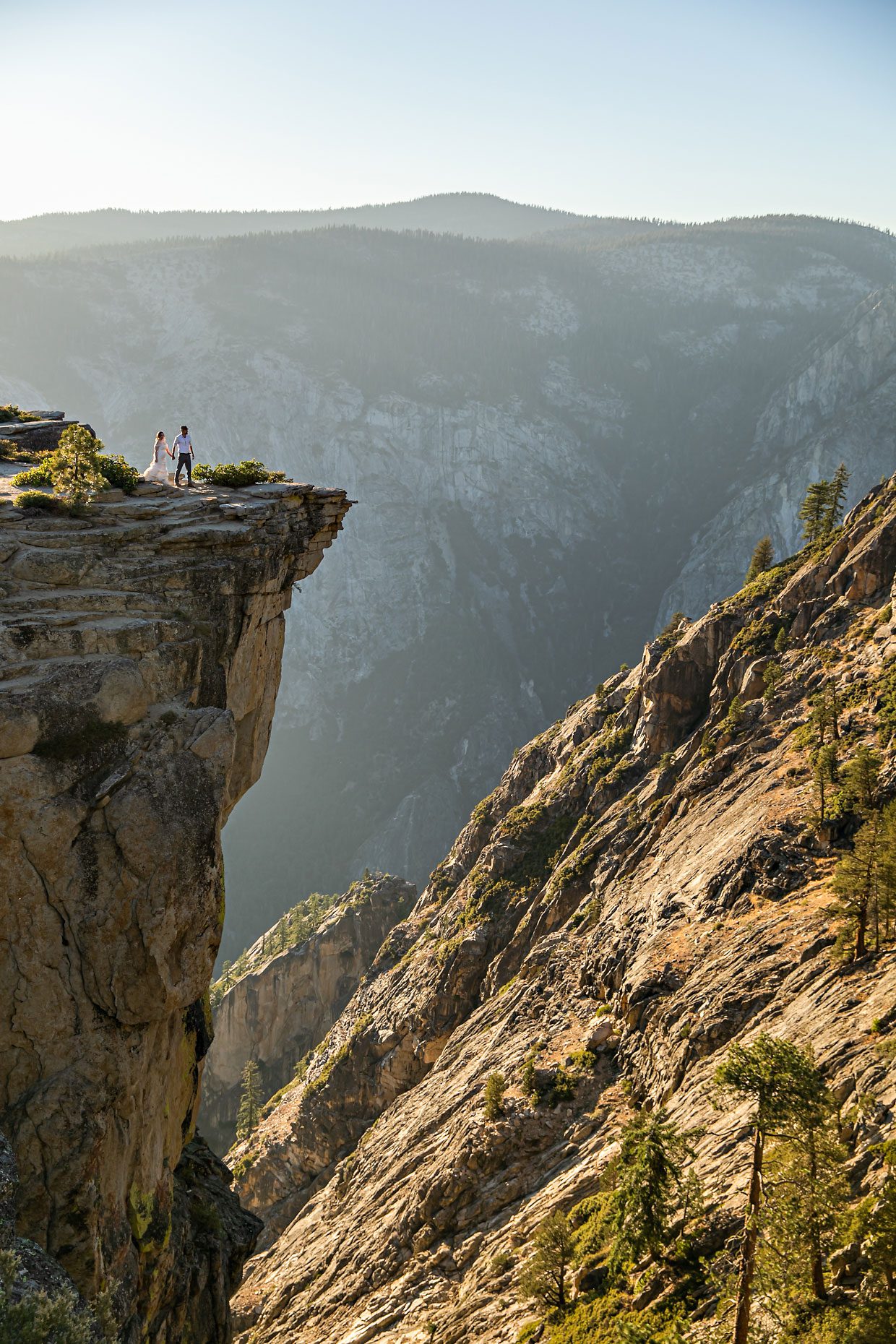 Couple gets wedding photography in Yosemite at Taft Point at sunset.