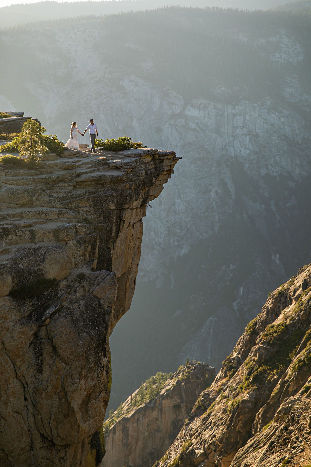 Couple gets wedding photography in Yosemite at Taft Point at sunset.