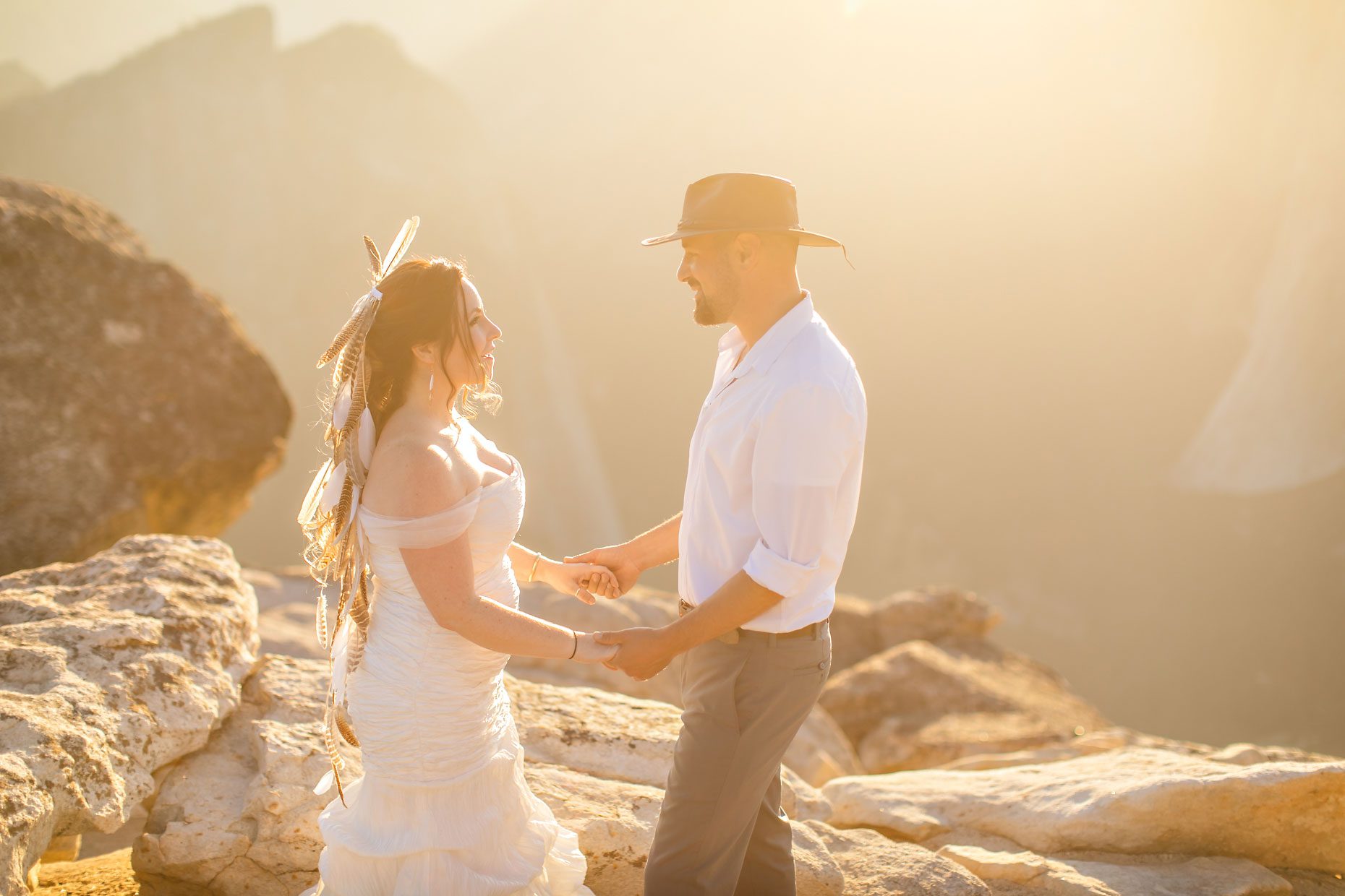 Couple gets wedding photography in Yosemite at Taft Point at sunset.