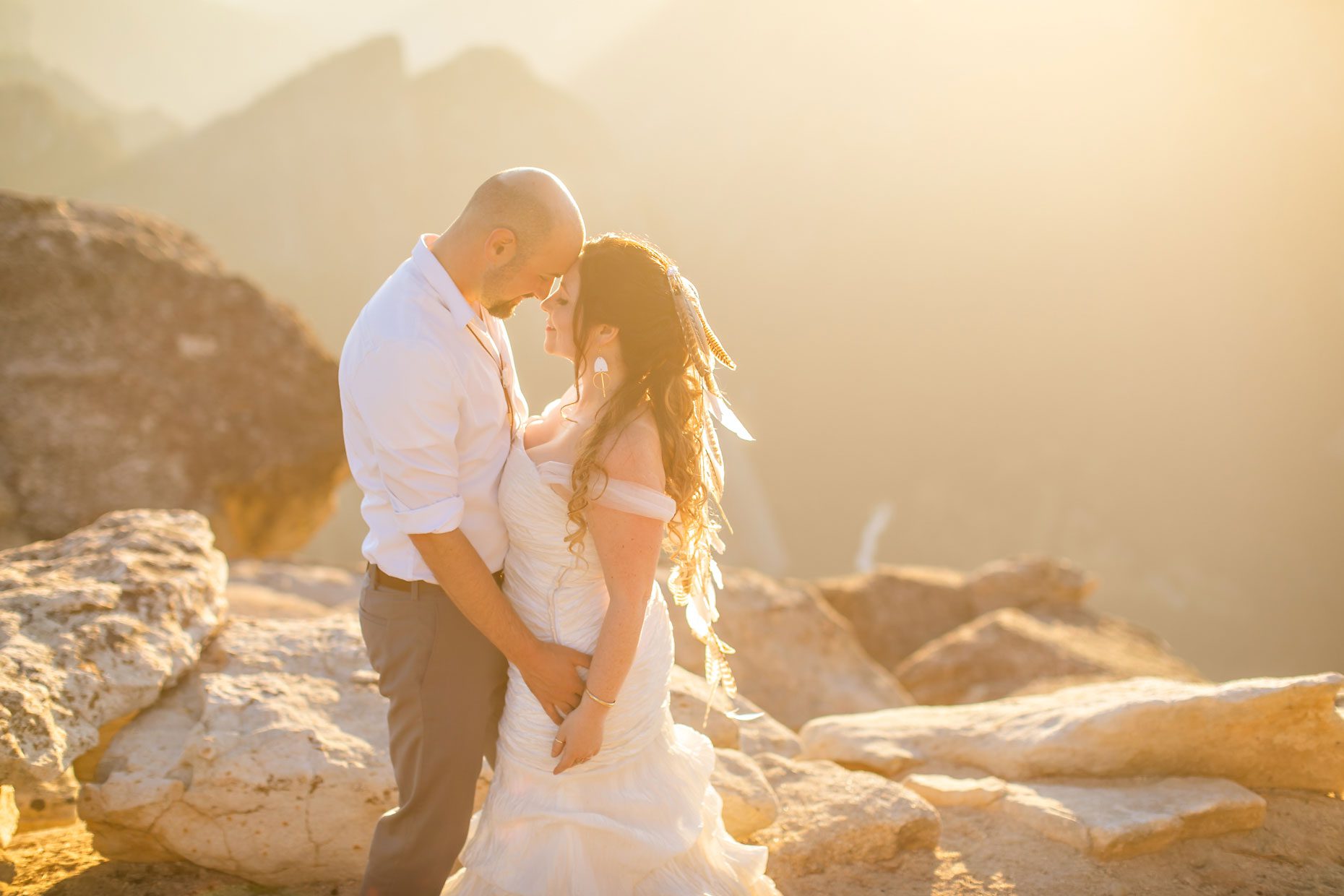 Couple gets wedding photography in Yosemite at Taft Point at sunset.
