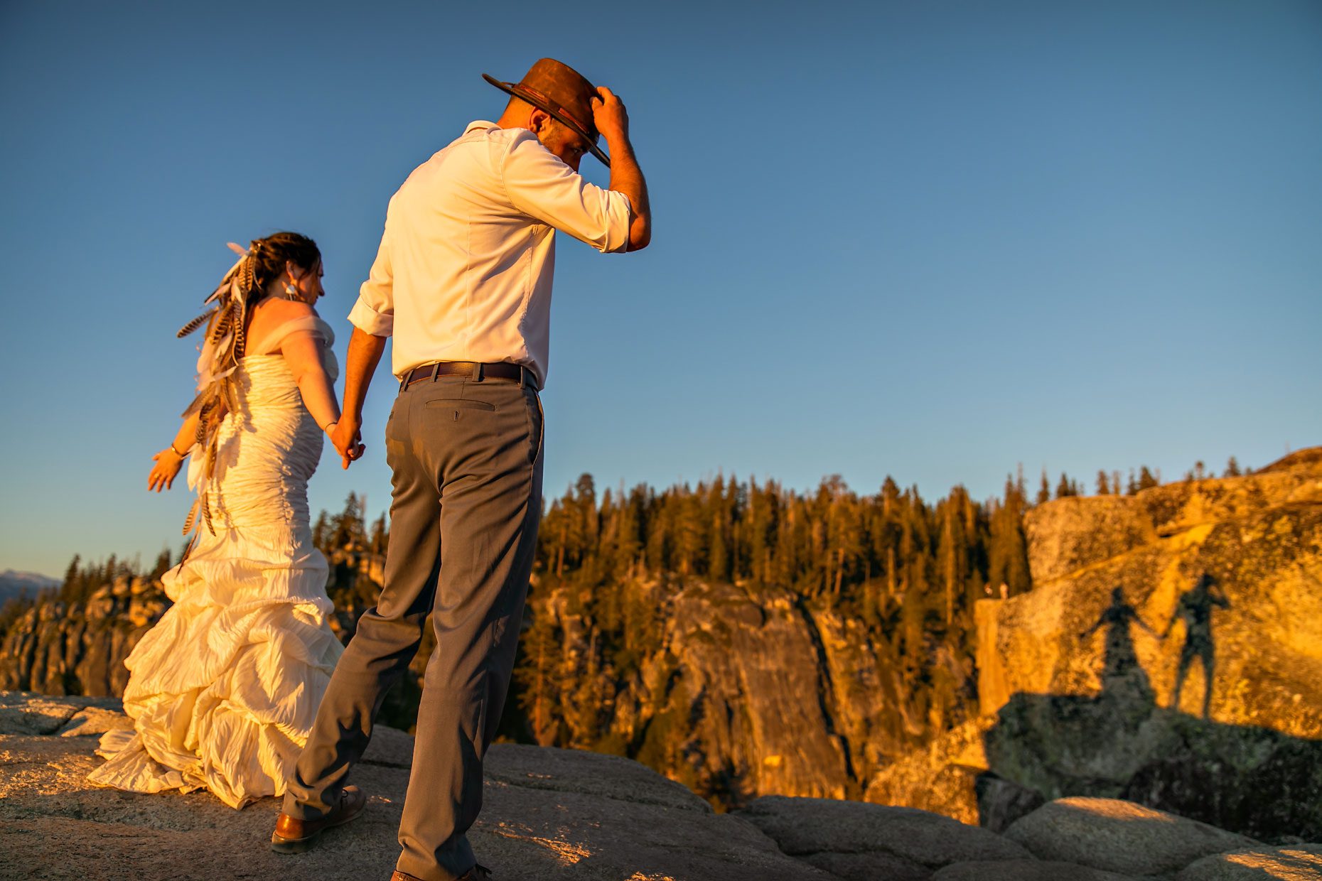 Couple gets wedding photography in Yosemite at Taft Point at sunset.