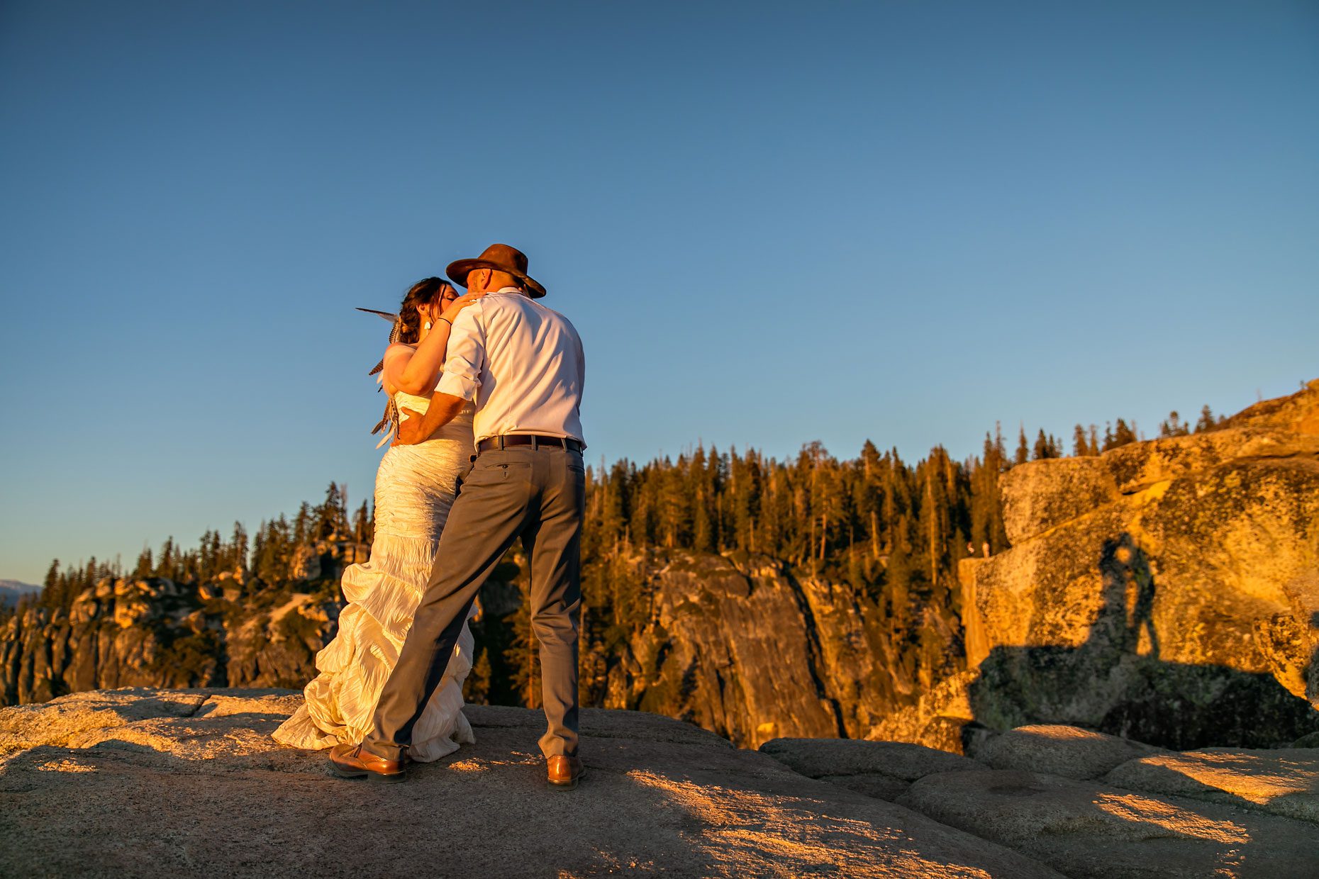 Couple gets wedding photography in Yosemite at Taft Point at sunset.