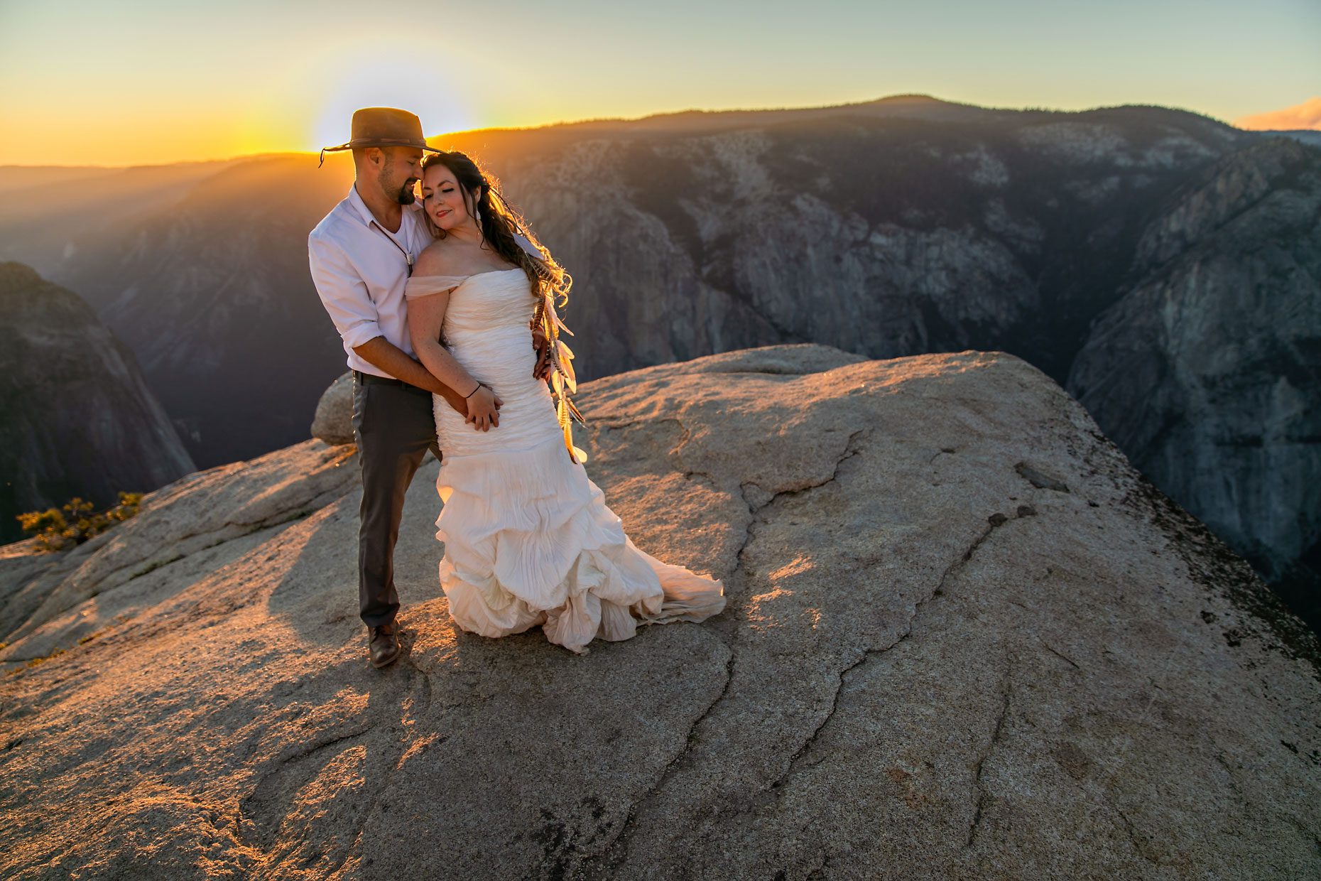 Couple gets wedding photography in Yosemite at Taft Point at sunset.