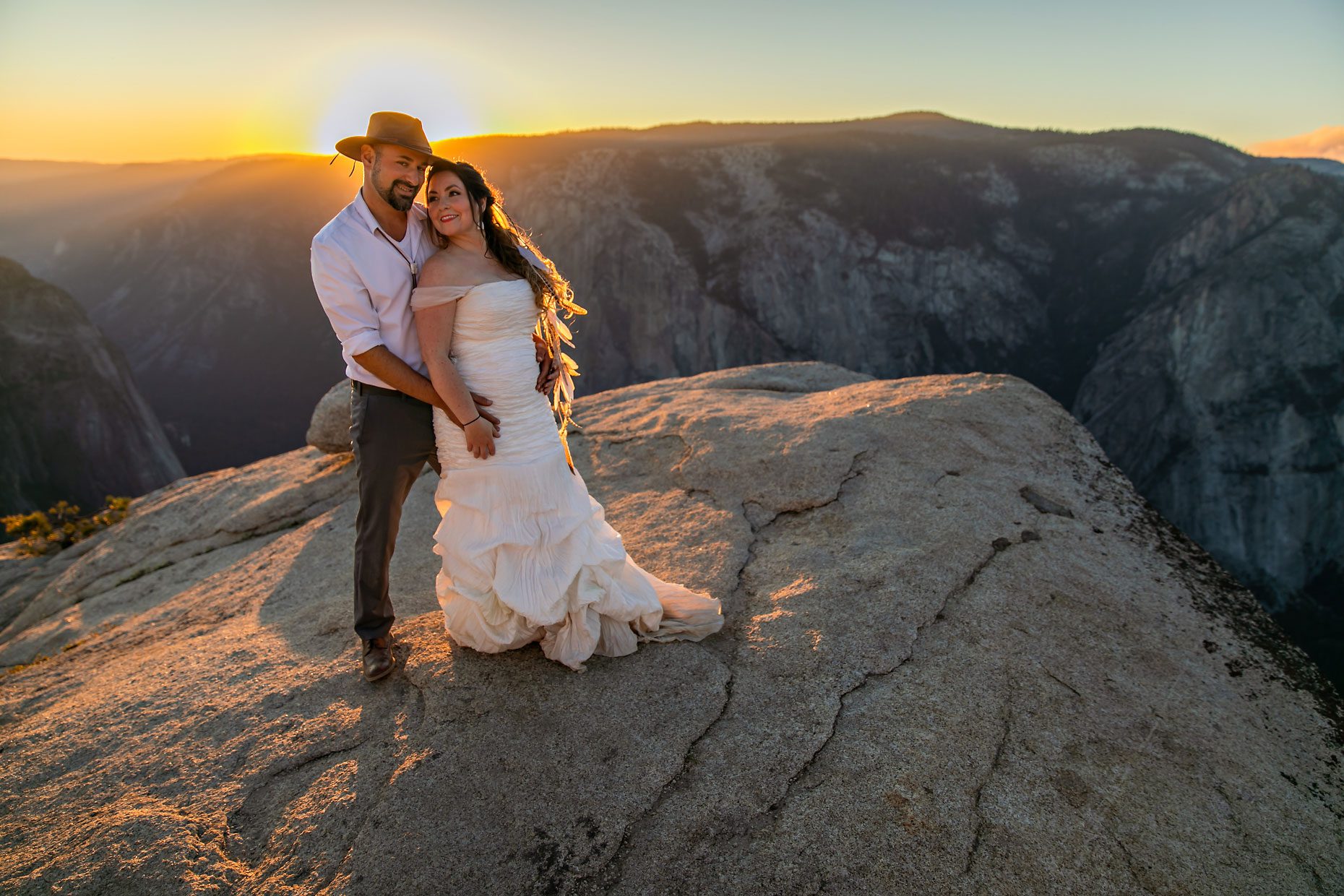 Couple gets wedding photography in Yosemite at Taft Point at sunset.