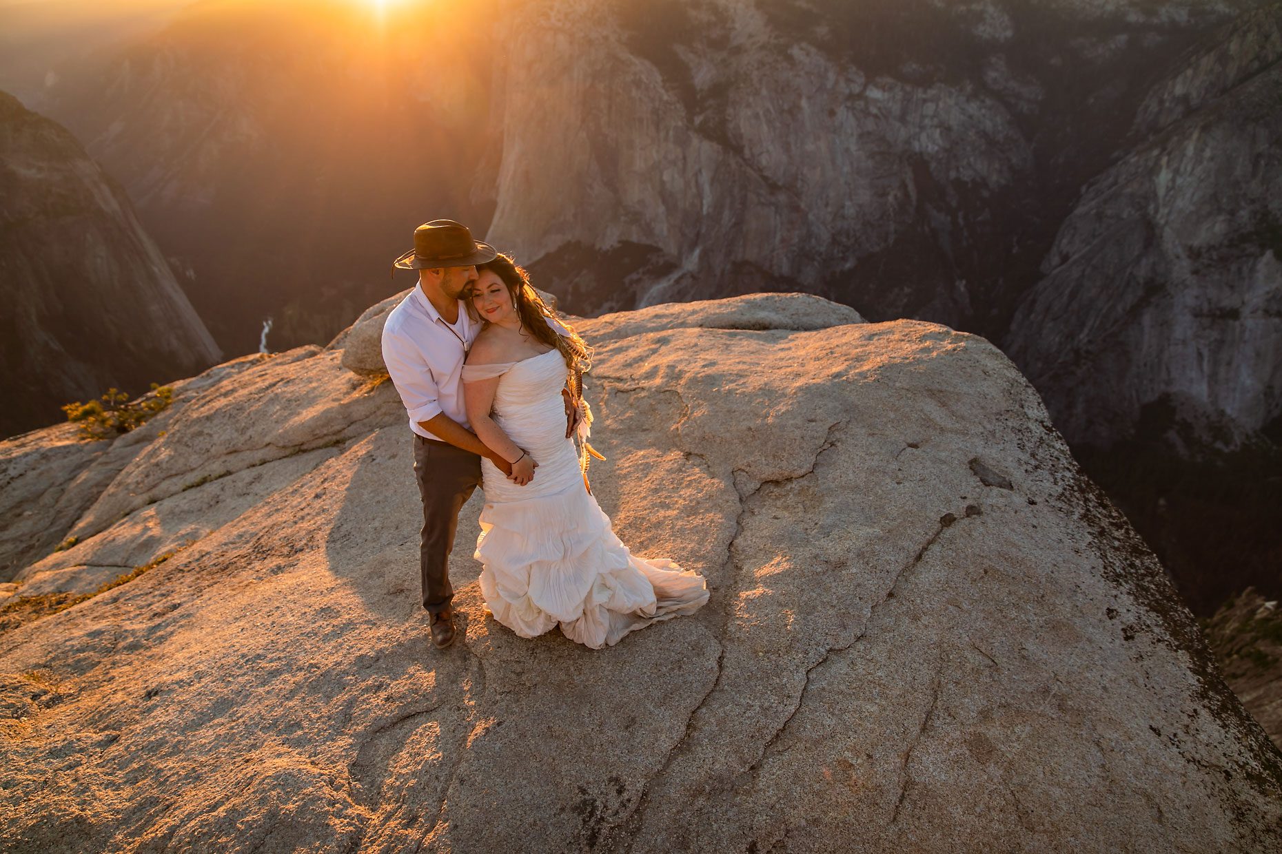Couple gets wedding photography in Yosemite at Taft Point at sunset.