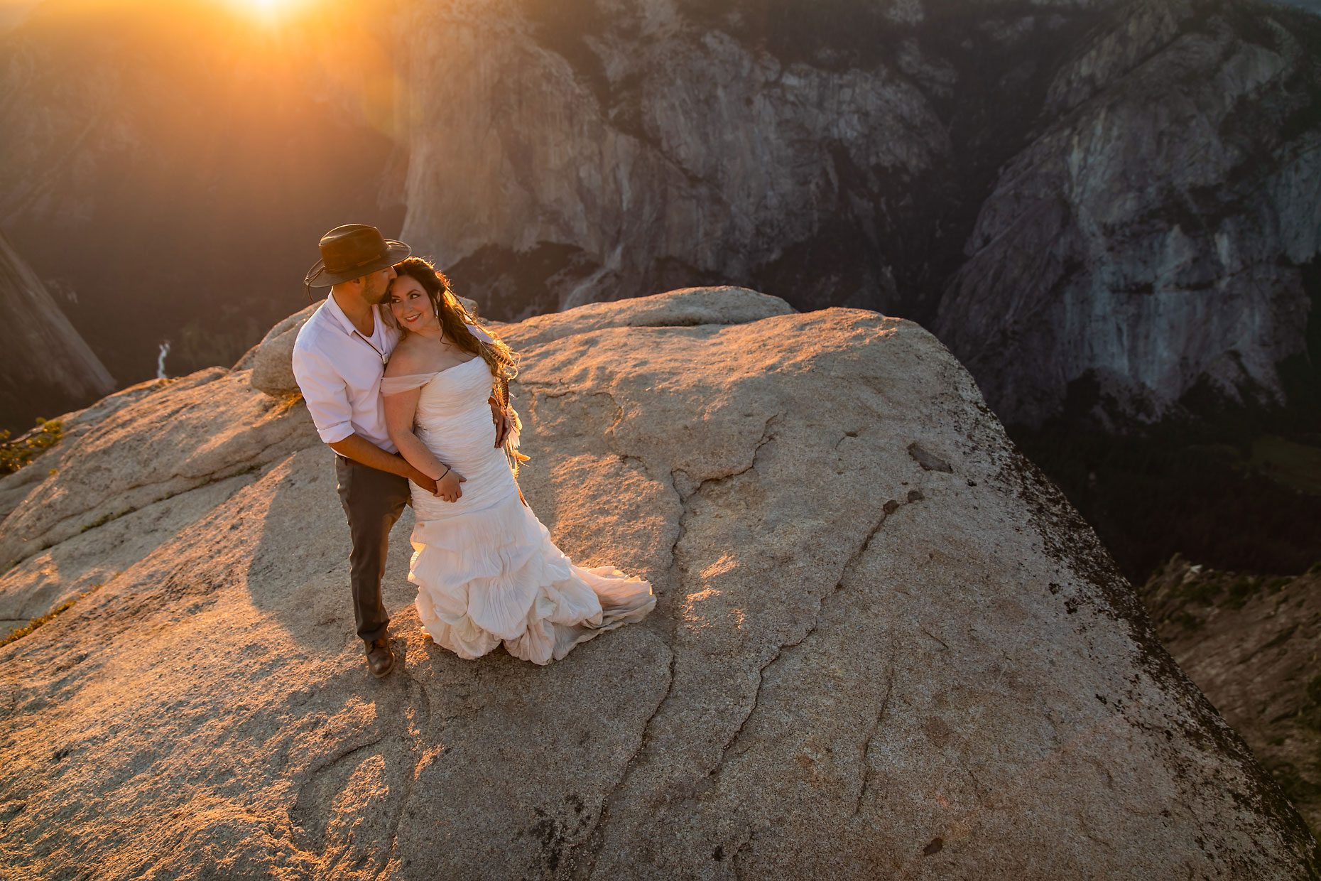 Couple gets wedding photography in Yosemite at Taft Point at sunset.