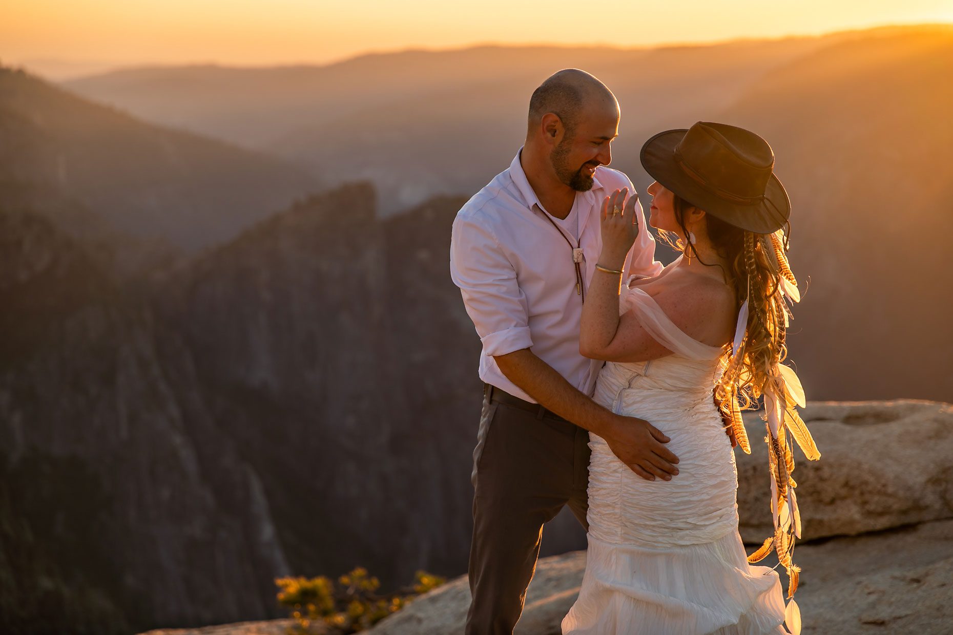 Couple gets wedding photography in Yosemite at Taft Point at sunset.