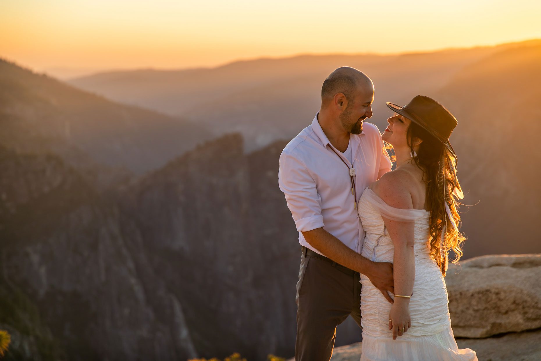 Couple gets wedding photography in Yosemite at Taft Point at sunset.