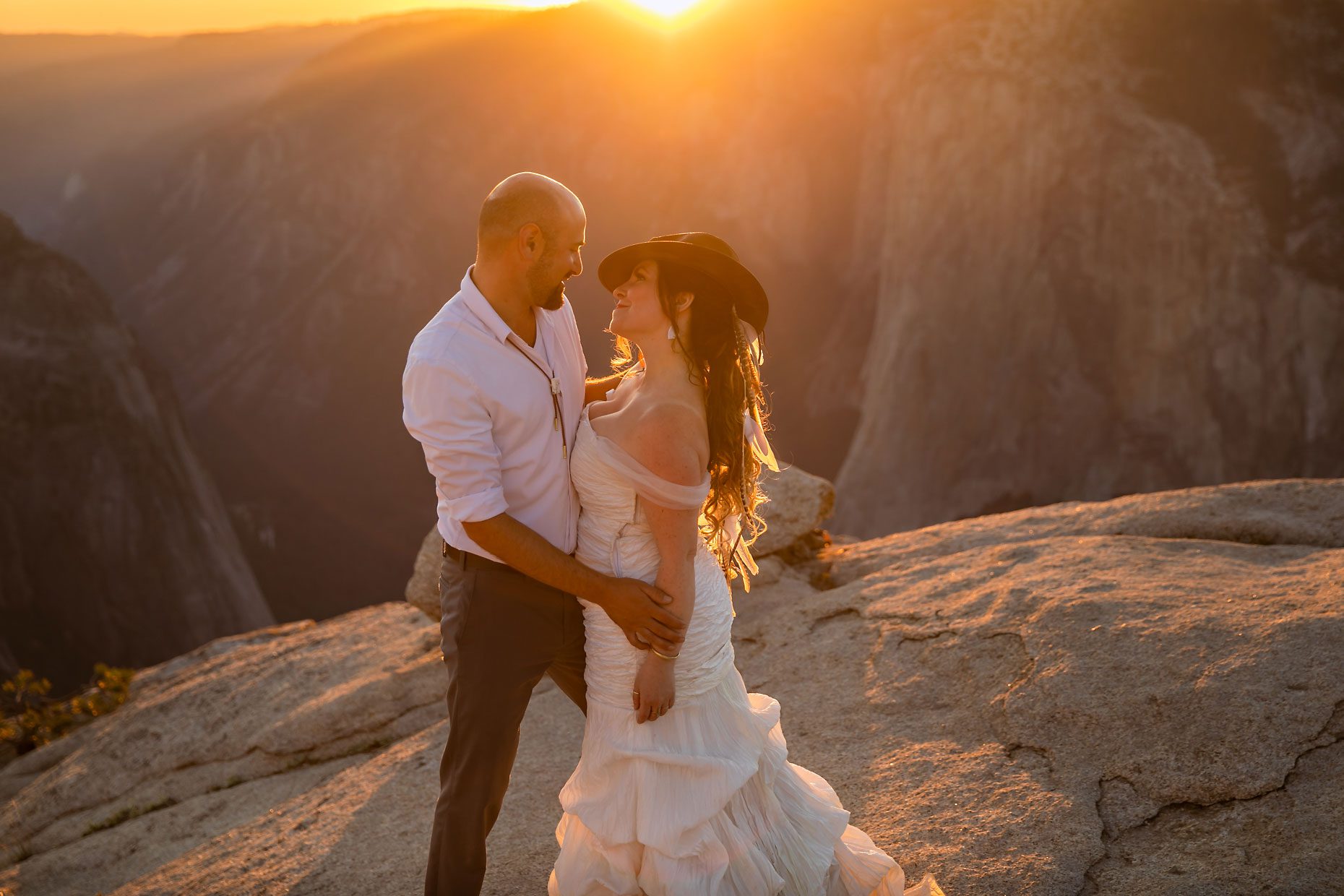 Couple gets wedding photography in Yosemite at Taft Point at sunset.