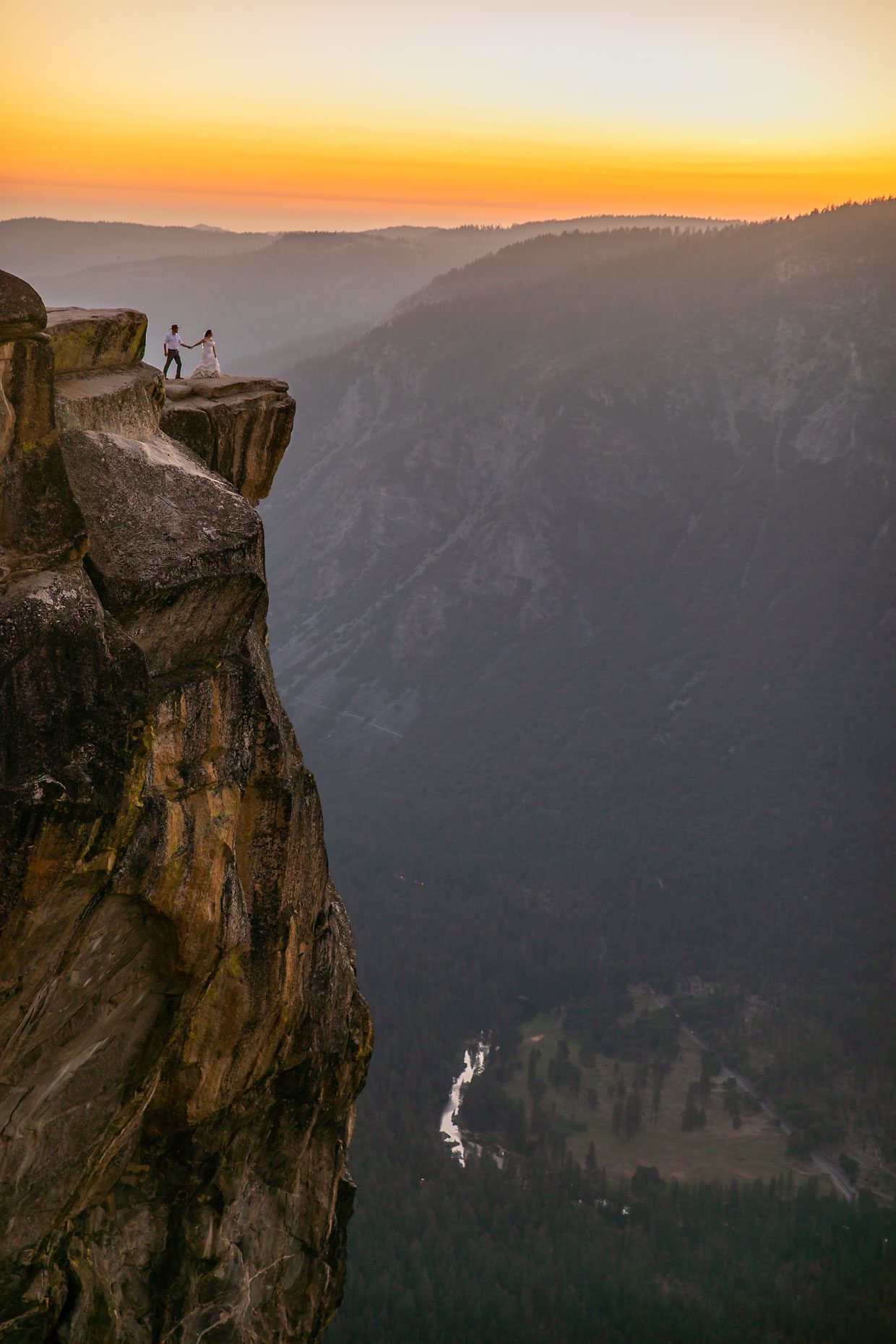 Couple gets wedding photography in Yosemite at Taft Point at sunset.