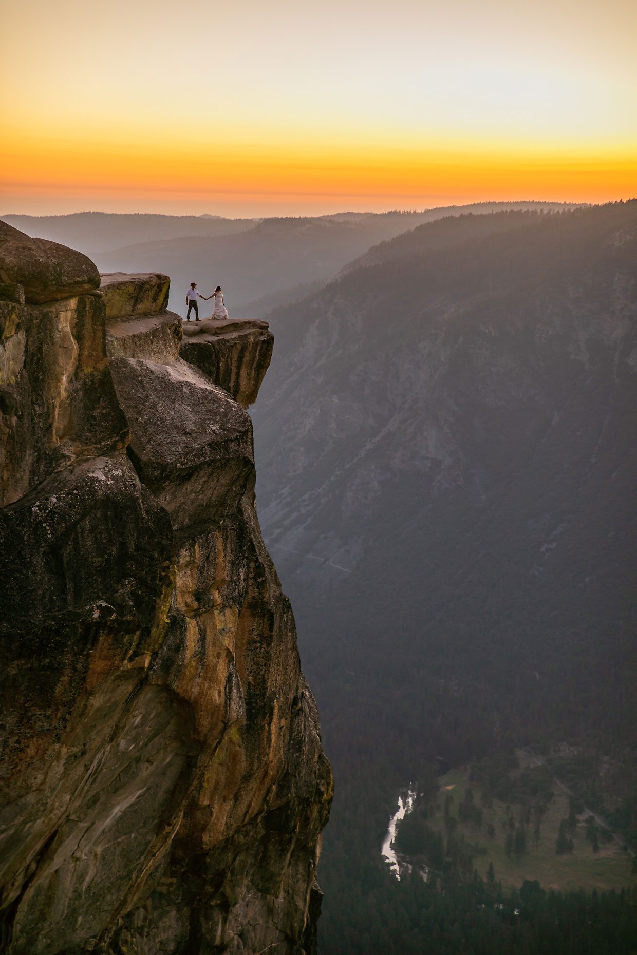Couple gets wedding photography in Yosemite at Taft Point at sunset.