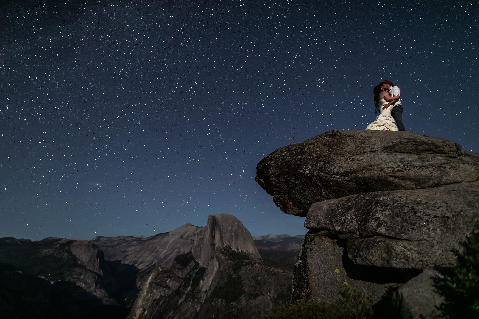 Couple gets wedding photography in Yosemite at Glacier Point under the stars.