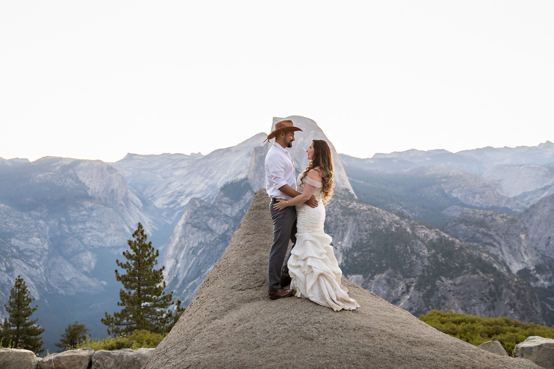 Couple gets wedding photography in Yosemite at Glacier Point at sunrise.