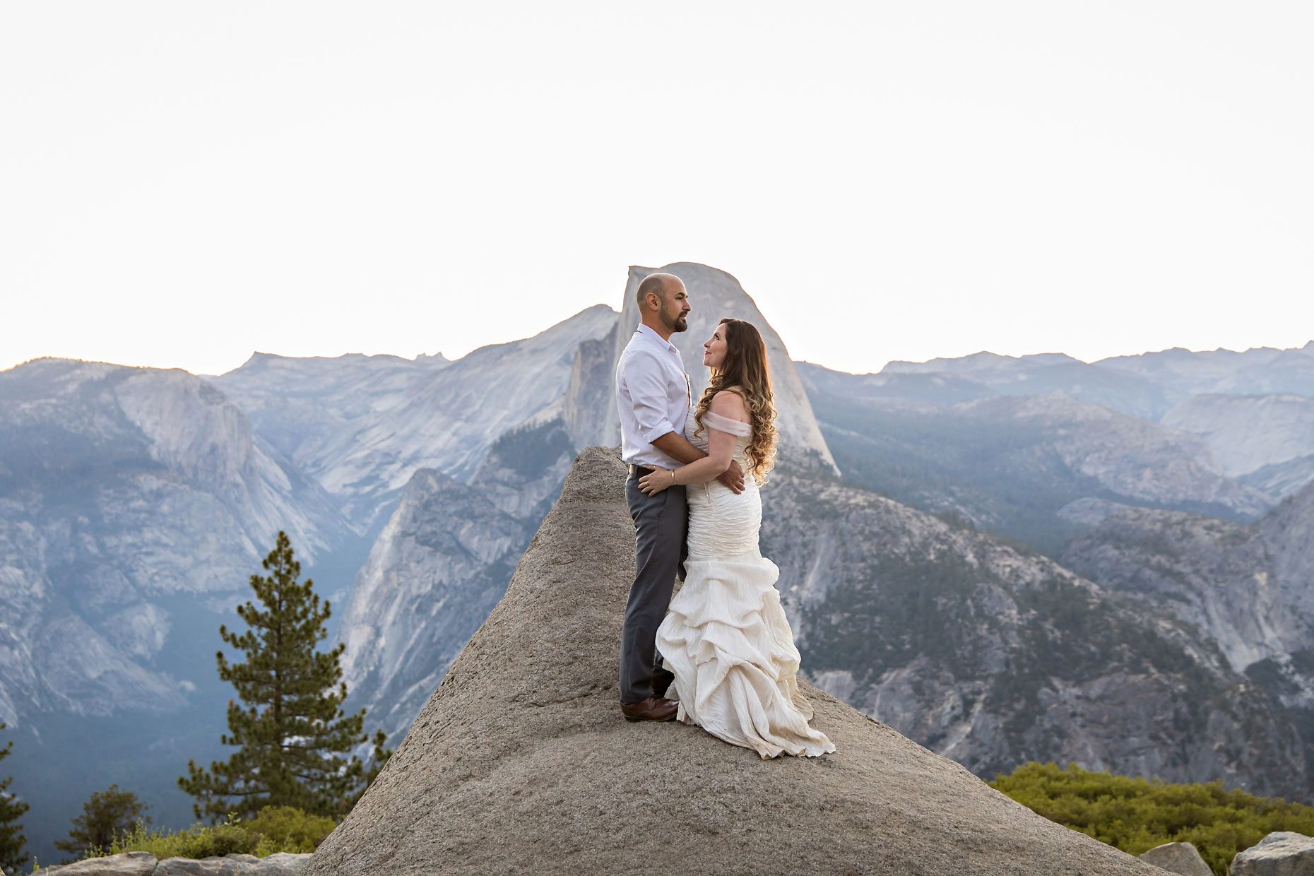 Couple gets wedding photography in Yosemite at Glacier Point at sunrise.