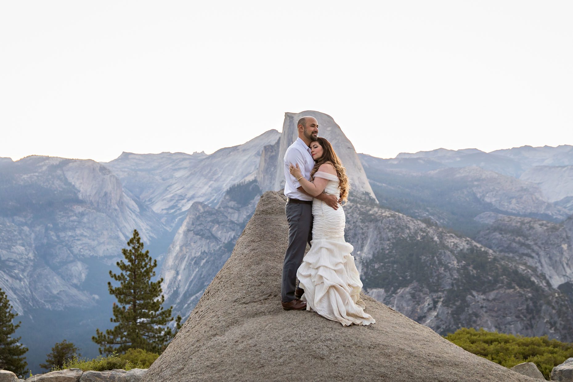 Couple gets wedding photography in Yosemite at Glacier Point at sunrise.