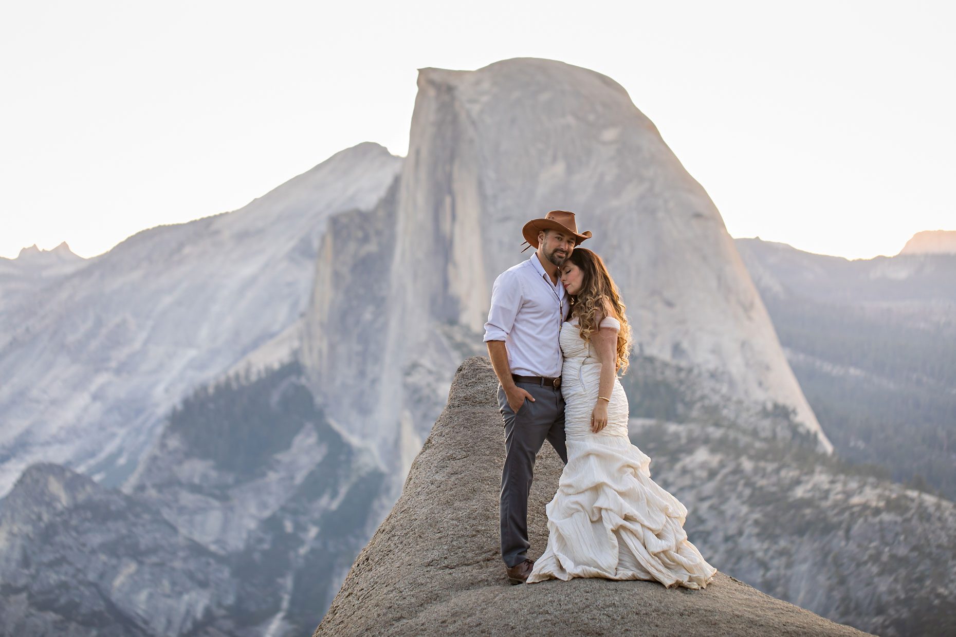 Couple gets wedding photography in Yosemite at Glacier Point at sunrise.