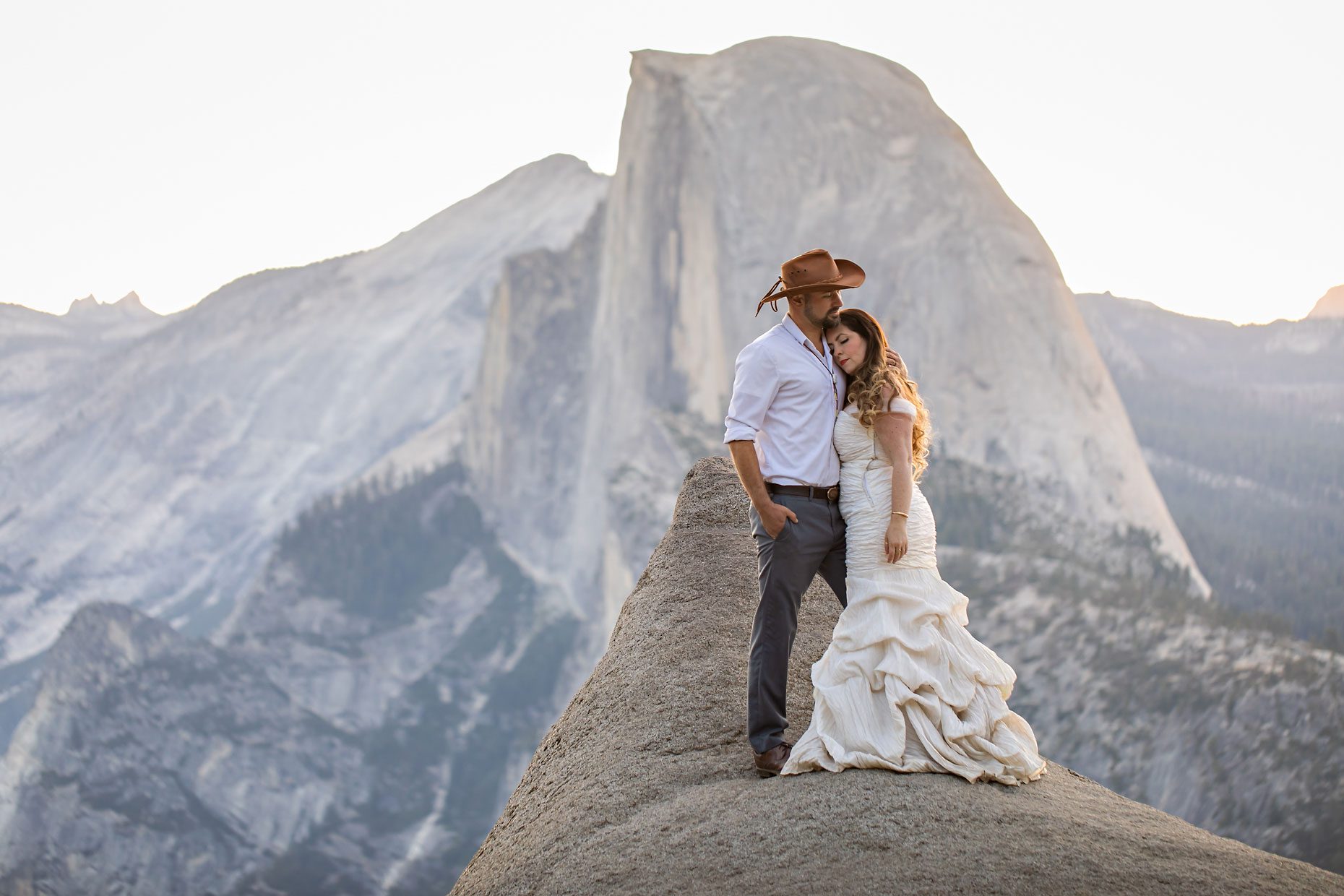 Couple gets wedding photography in Yosemite at Glacier Point at sunrise.