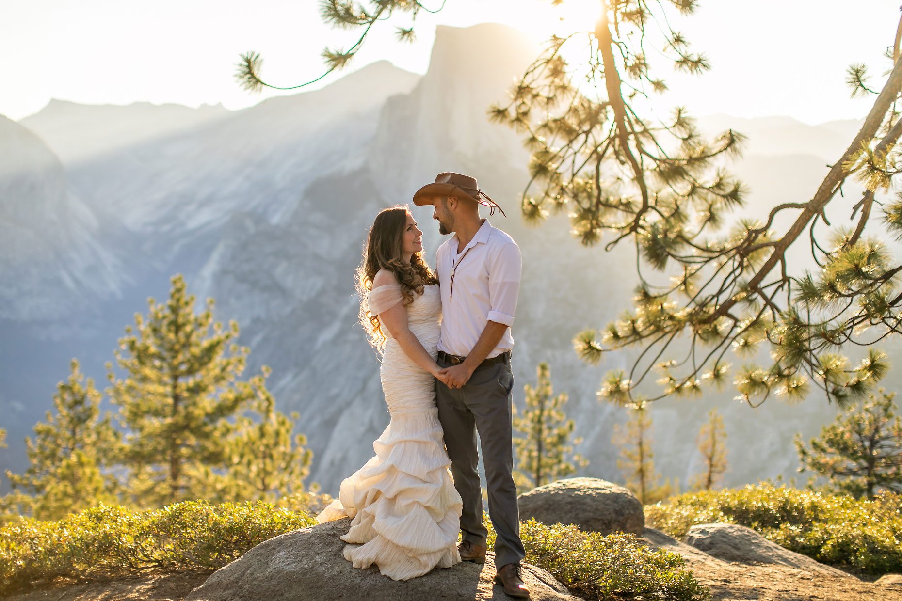 Couple gets wedding photography in Yosemite at Glacier Point at sunrise.