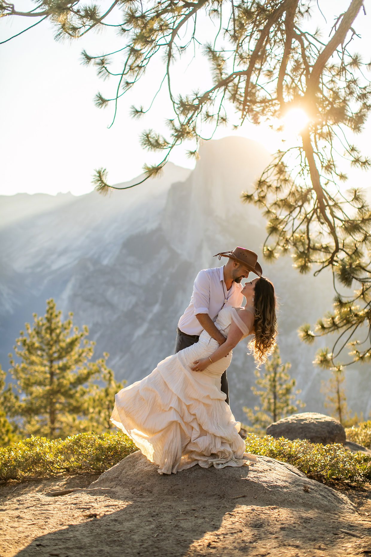 Couple gets wedding photography in Yosemite at Glacier Point at sunrise.