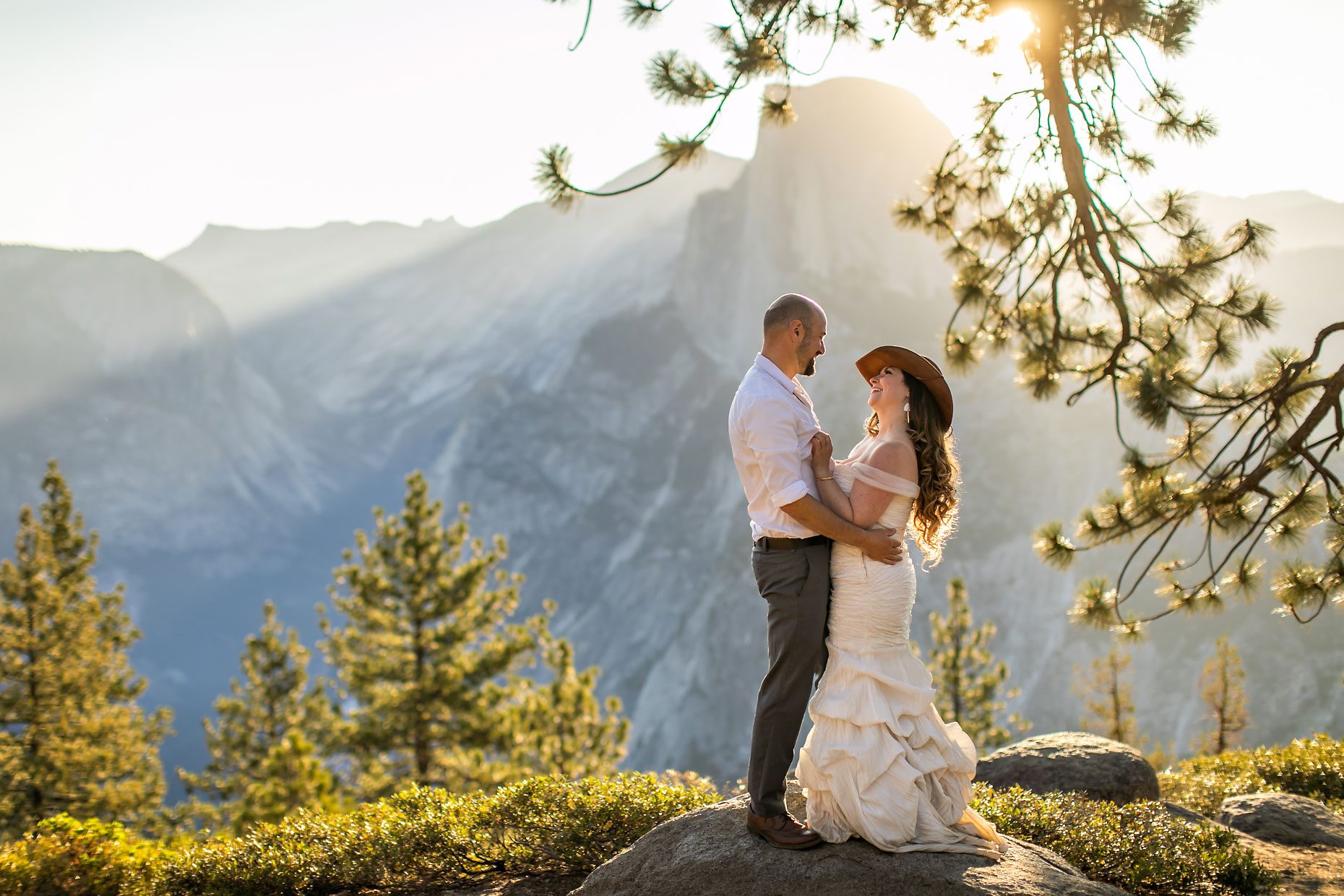 Couple gets wedding photography in Yosemite at Glacier Point at sunrise.