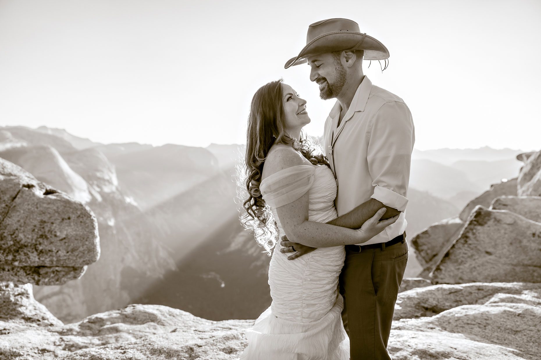 Couple gets wedding photography in Yosemite at Glacier Point at sunrise.