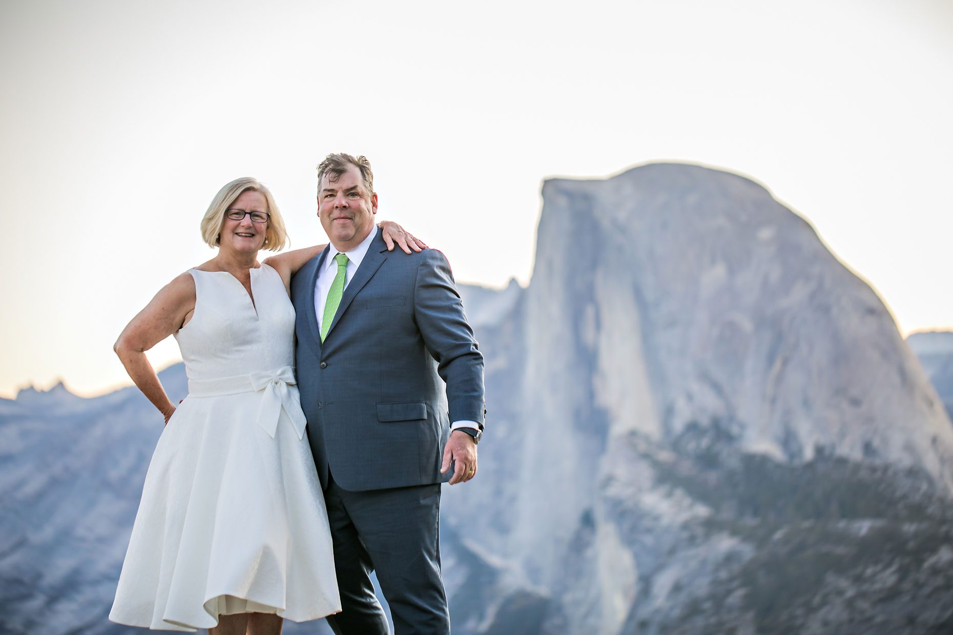 Couple gets wedding photography in Yosemite National Park at Glacier Point at sunrise.