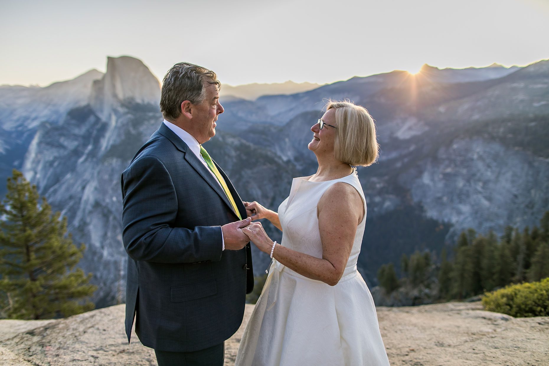 Couple gets wedding photography in Yosemite National Park at Glacier Point at sunrise.