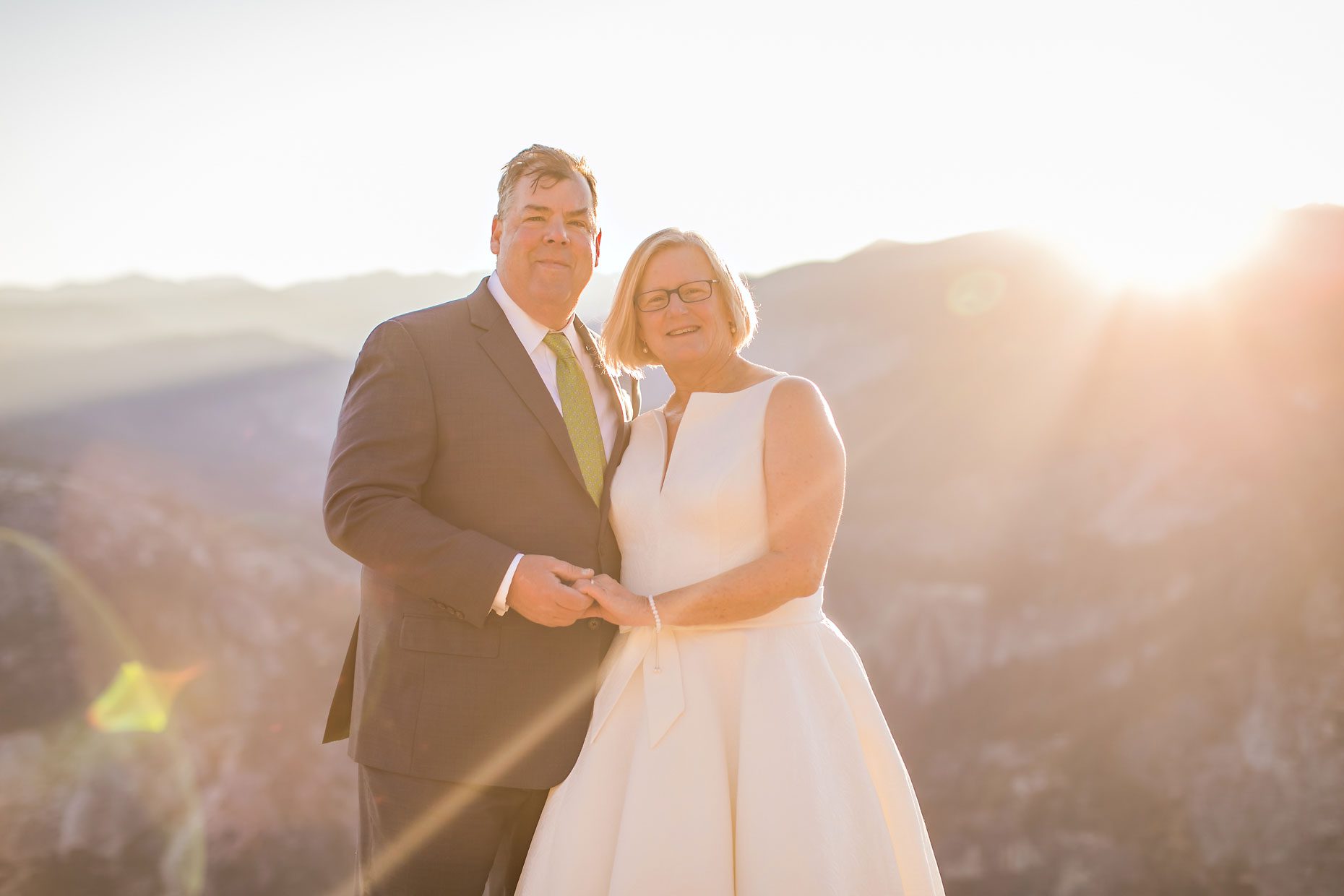 Couple gets wedding photography in Yosemite National Park at Glacier Point at sunrise.