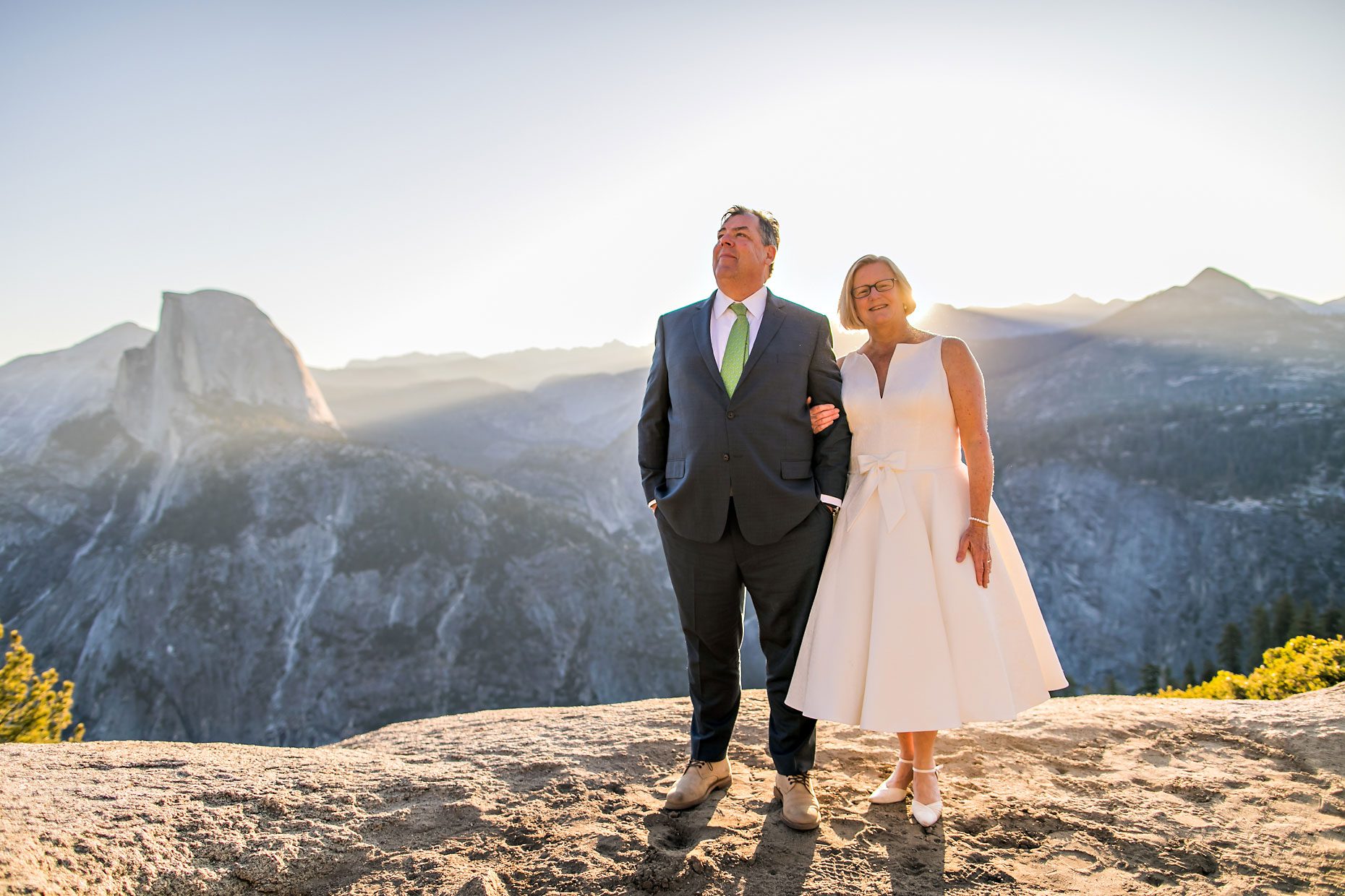 Couple gets wedding photography in Yosemite National Park at Glacier Point at sunrise.