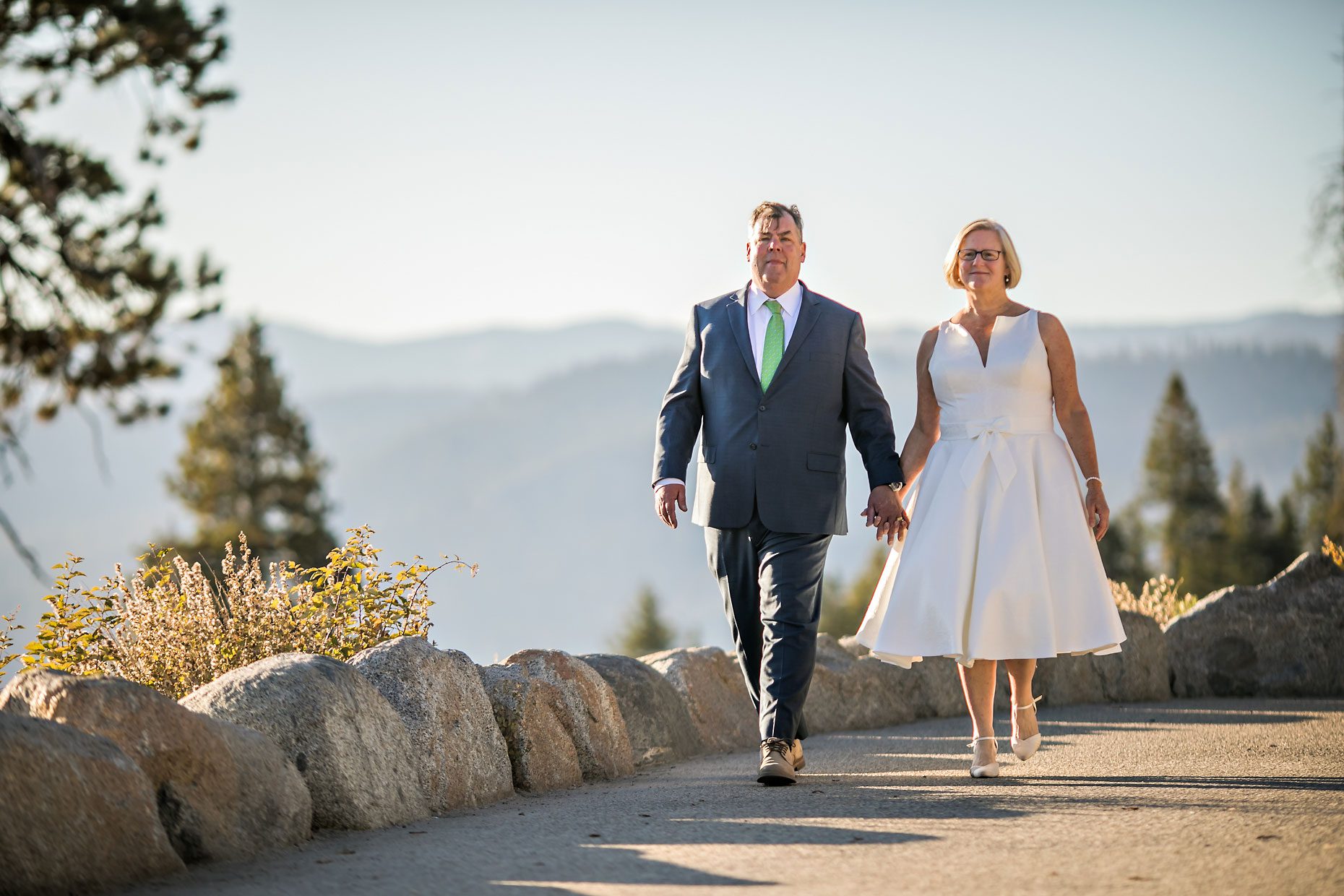 Couple gets wedding photography in Yosemite National Park at Glacier Point at sunrise.