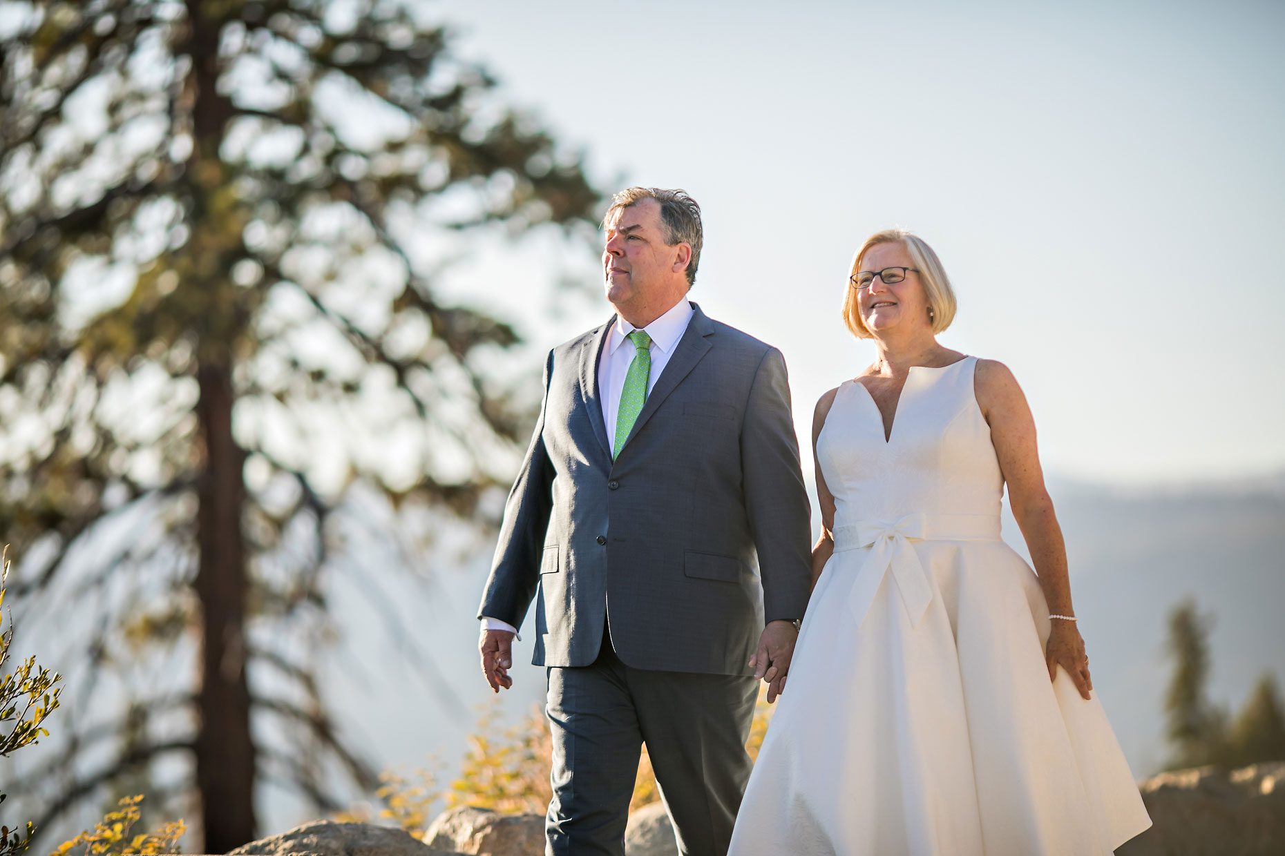 Couple gets wedding photography in Yosemite National Park at Glacier Point at sunrise.