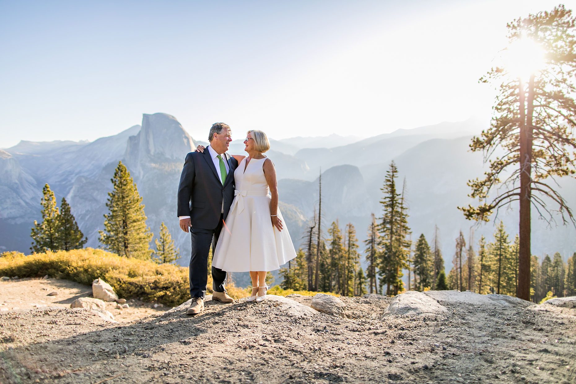 Couple gets wedding photography in Yosemite National Park at Glacier Point at sunrise.