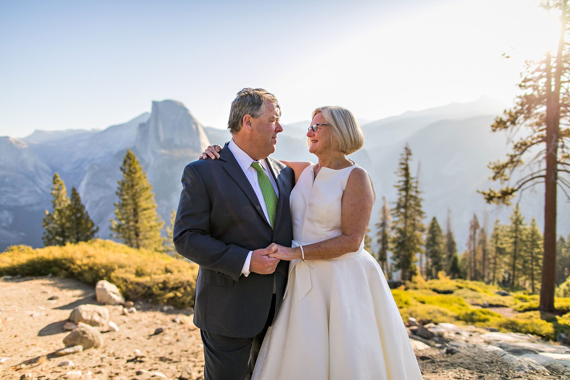 Couple gets wedding photography in Yosemite National Park at Glacier Point at sunrise.