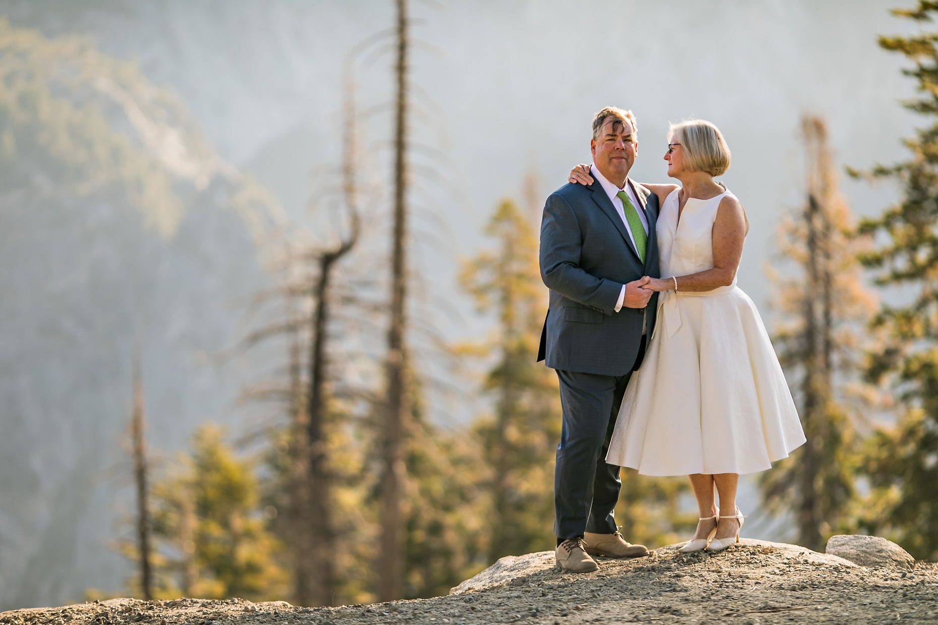 Couple gets wedding photography in Yosemite National Park at Glacier Point at sunrise.
