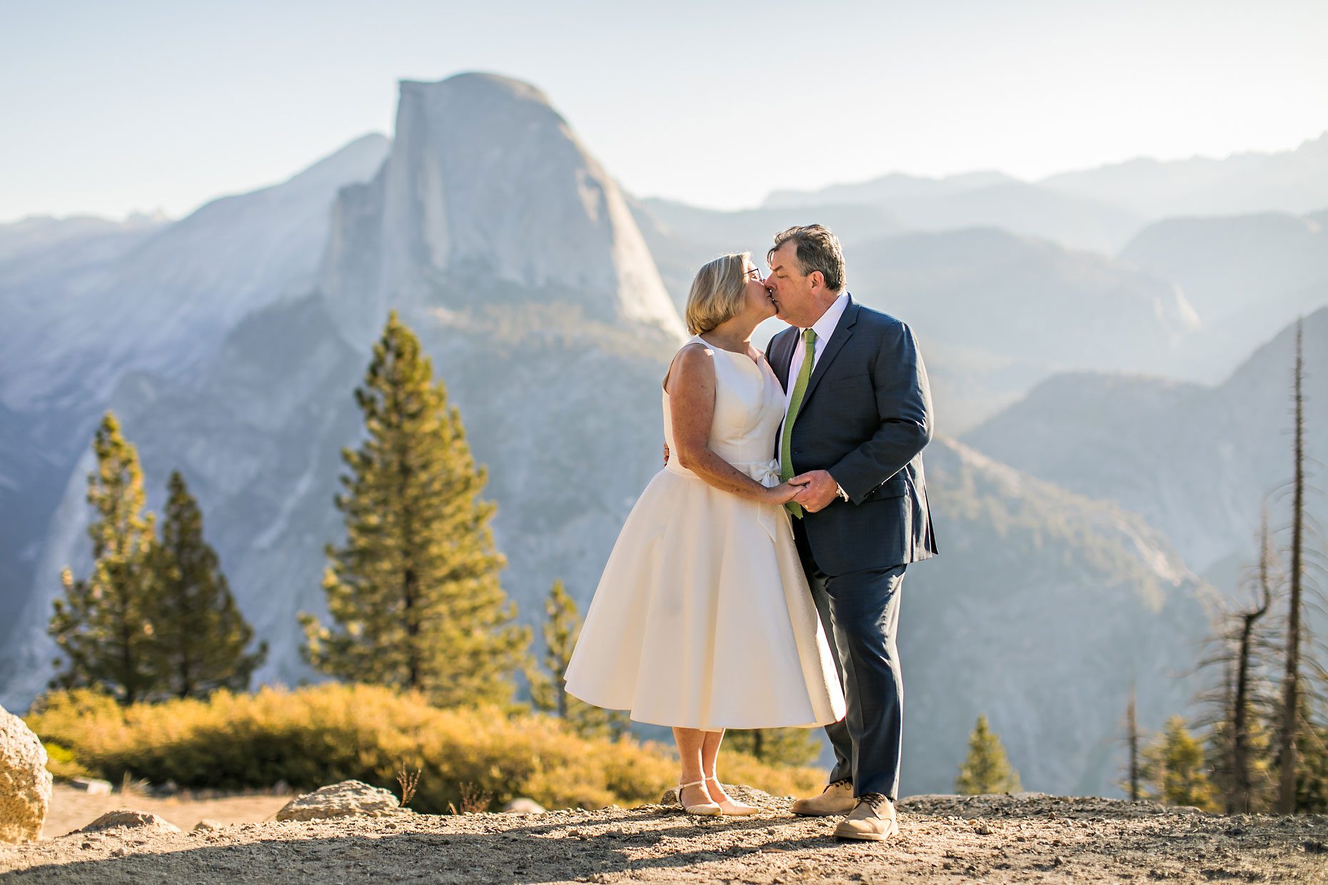 Couple gets wedding photography in Yosemite National Park at Glacier Point at sunrise.