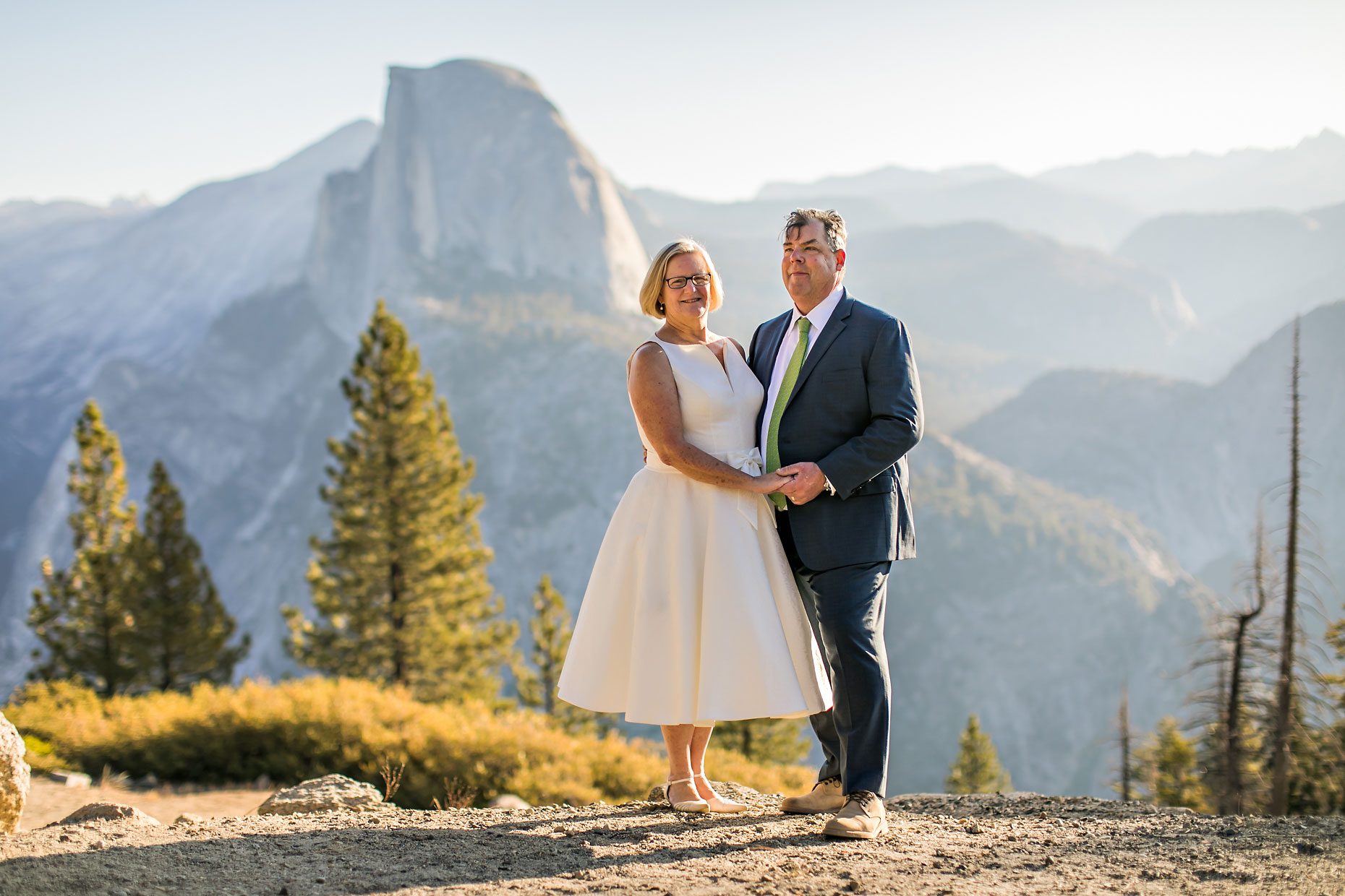 Couple gets wedding photography in Yosemite National Park at Glacier Point at sunrise.