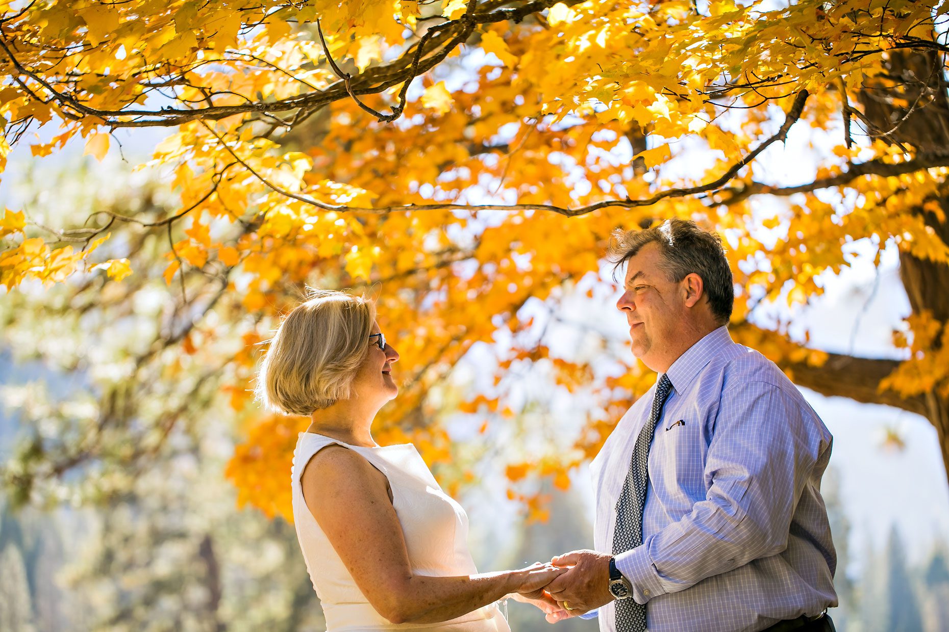 Wedding couple gets photographer to capture photos of them in Yosemite meadow.