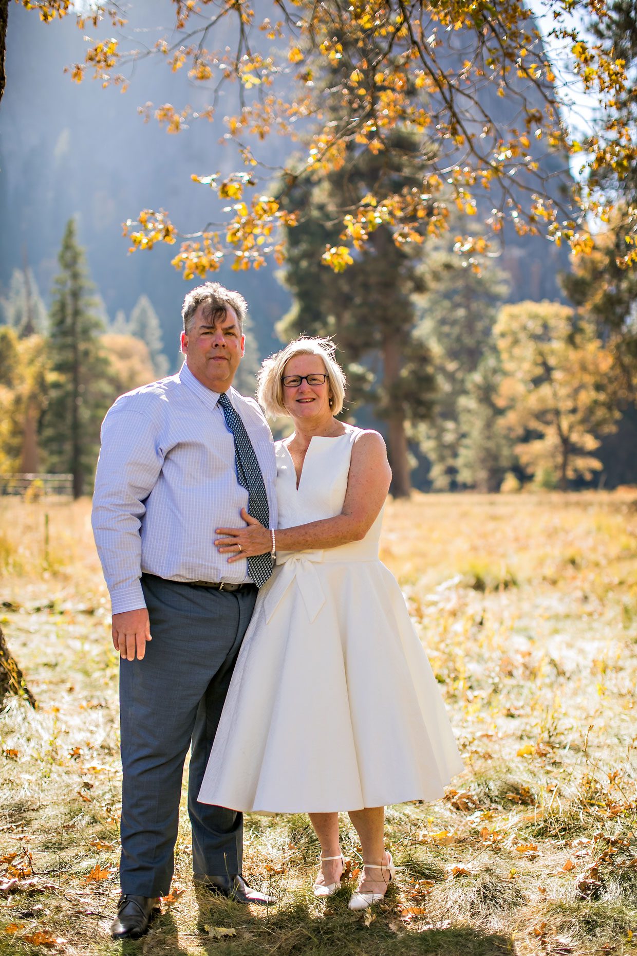 Wedding couple gets photographer to capture photos of them in Yosemite meadow.