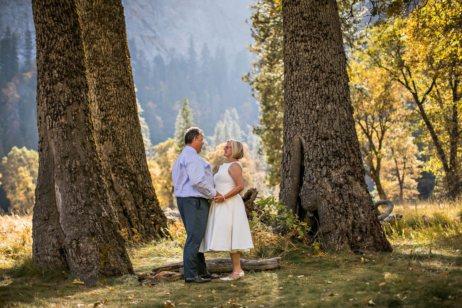 Wedding couple gets photographer to capture photos of them in Yosemite meadow.
