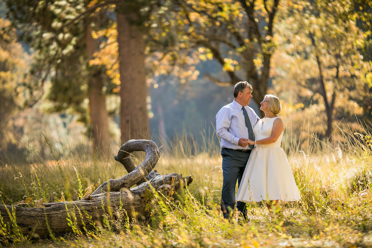 Wedding couple gets photographer to capture photos of them in Yosemite meadow.