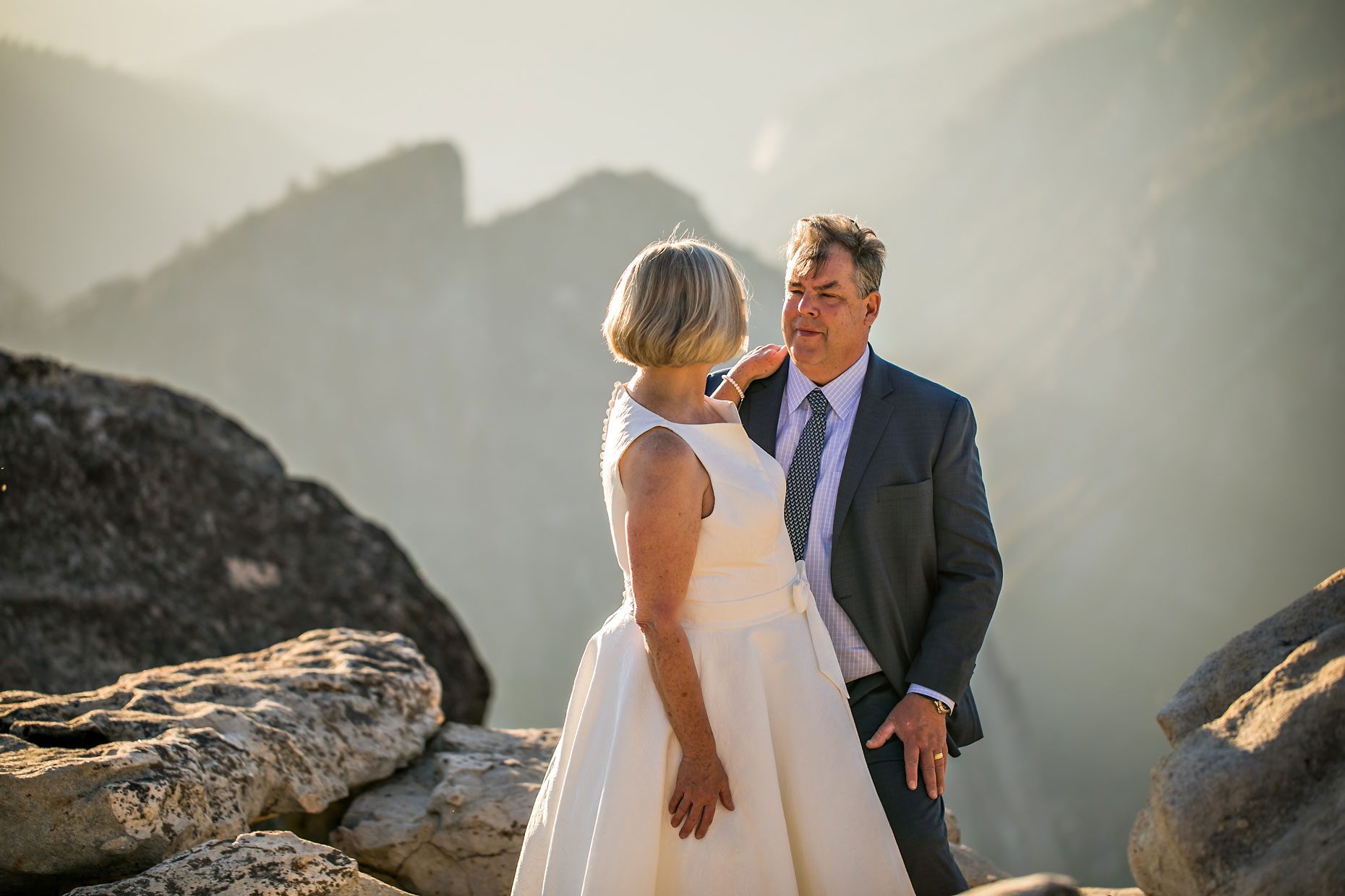 Wedding couple in love at Taft Point in Yosemite for adventure session photography at sunset.