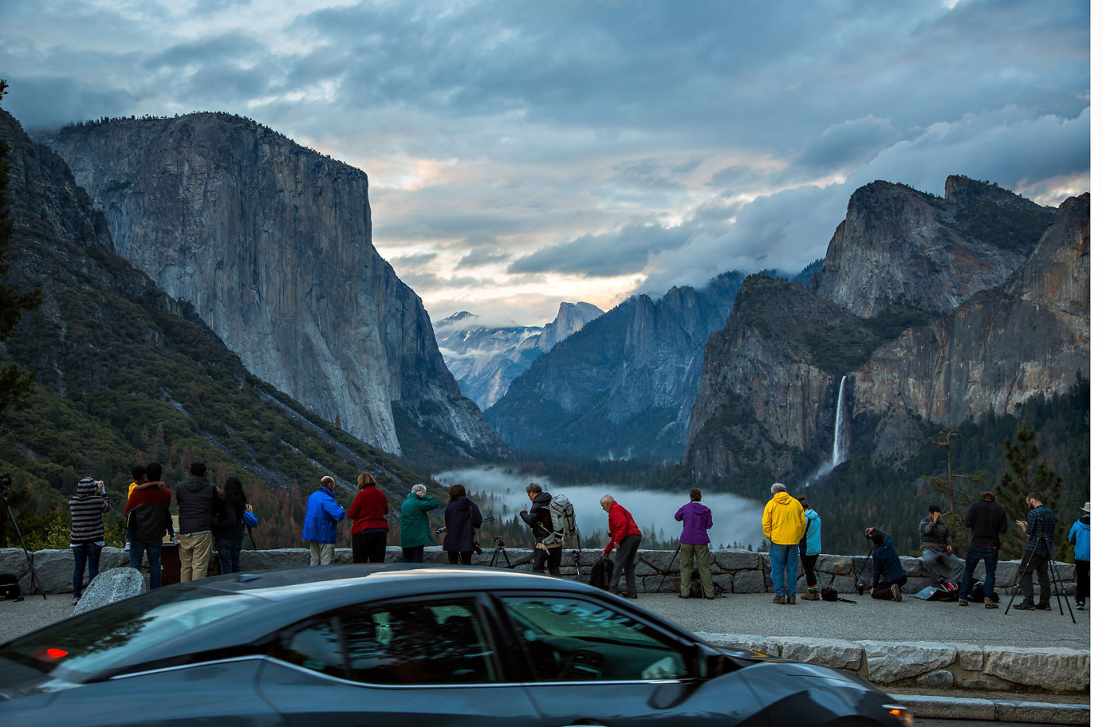 Crowd of people and car at Tunnel View.
