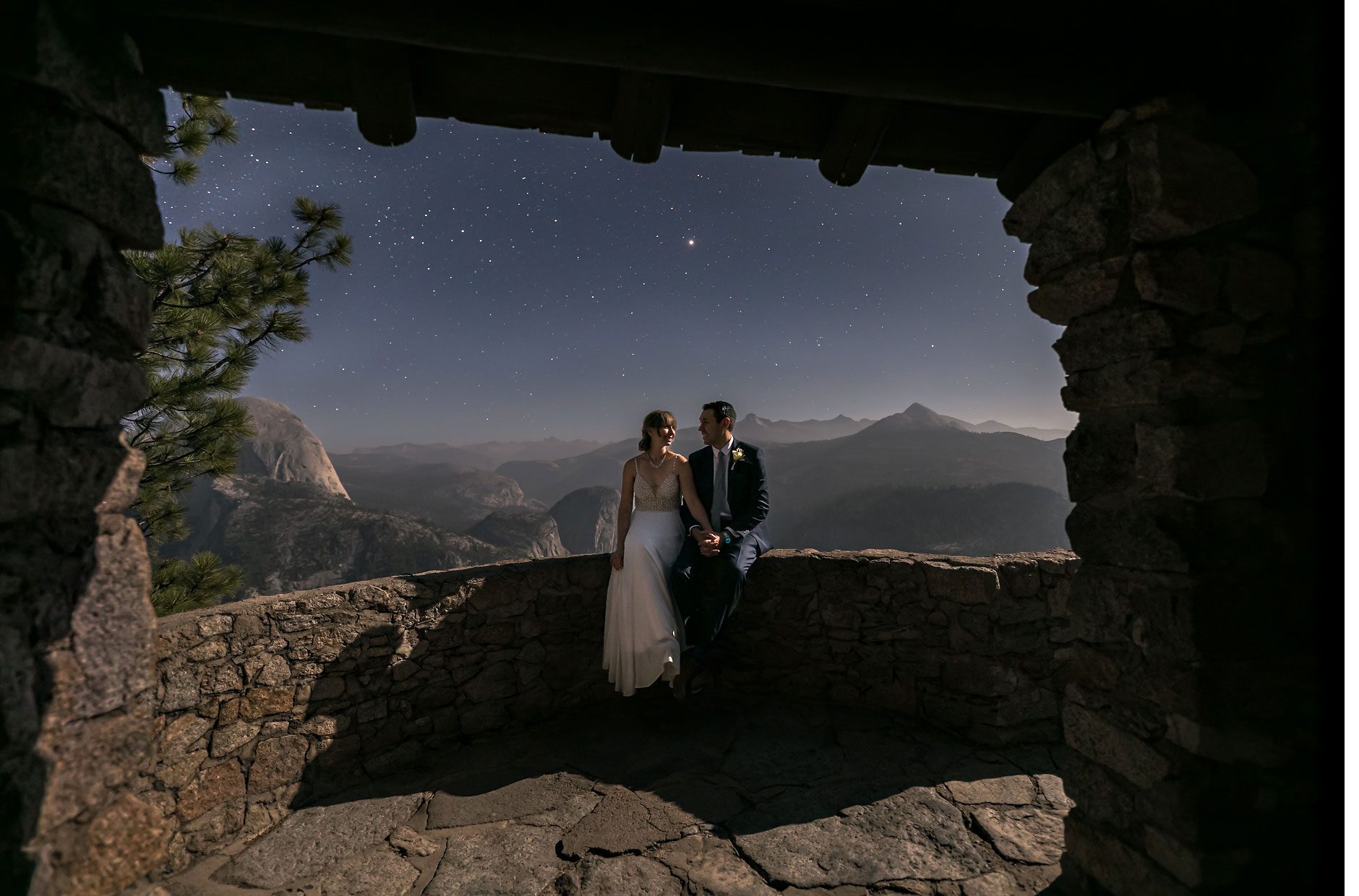 Wedding couple under stars at Geologic hut in Yosemite.