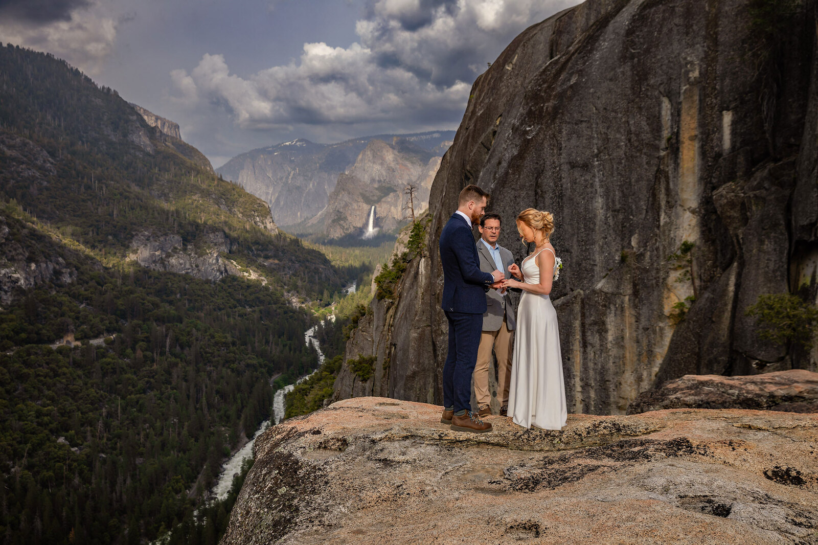 A Bride and Groom getting married on an edge of a cliff with a waterfall in the background