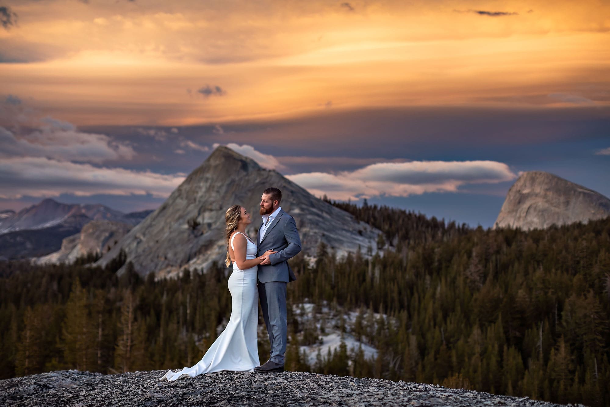 Mountain wedding photography at sunset on alpine Sierra dome.