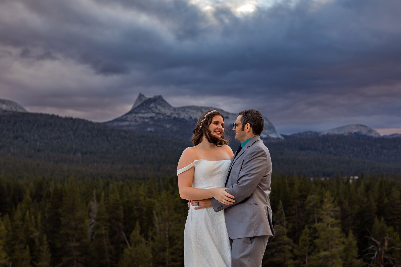 Wedding couple in mountains with storm light.