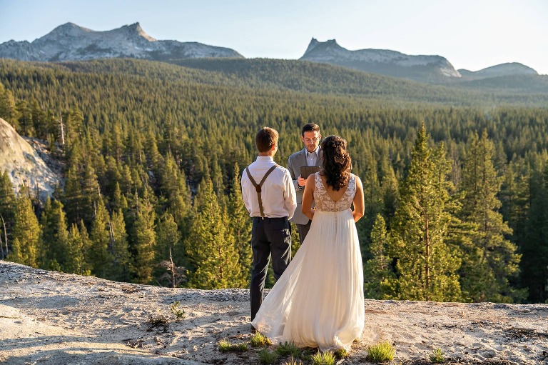 Bride and groom on granite dome in Yosemite